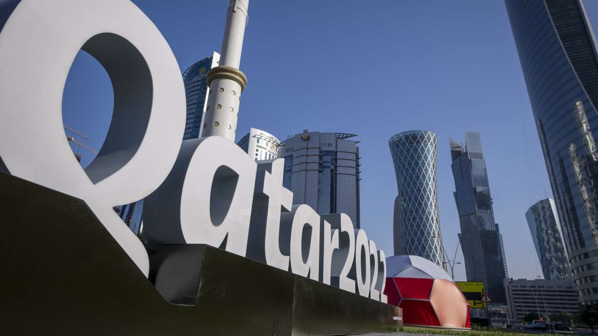 FILE - Branding is displayed near the Doha Exhibition and Convention Center in Doha, Qatar, Thursday, March 31, 2022. Qatar’s ruling emir has lashed out at criticism of the country over its hosting of the 2022 FIFA World Cup, complaining of an “unprecedented campaign” targeting the first Arab nation to hold the tournament.