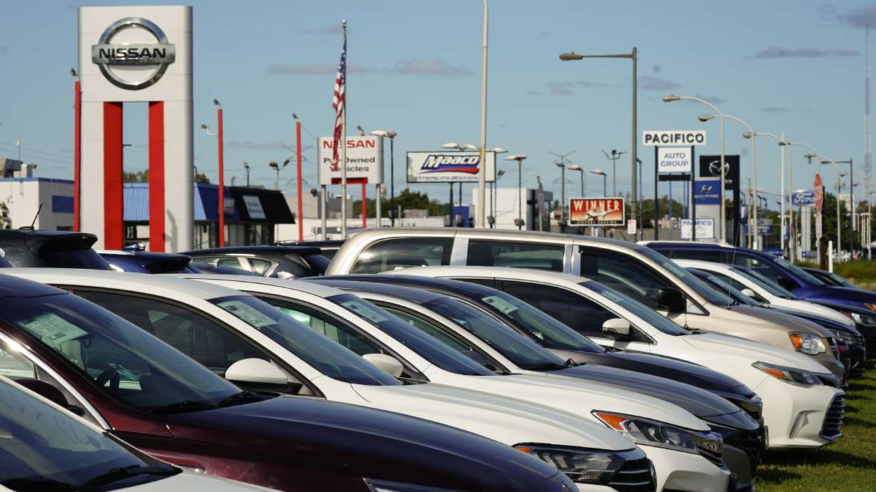 Cars for sale line the road at a used auto dealership in Philadelphia on Sept. 29. The prices of new and used vehicles in the United States have begun inching down from their eye-watering record highs as more vehicles have become gradually available at dealerships.