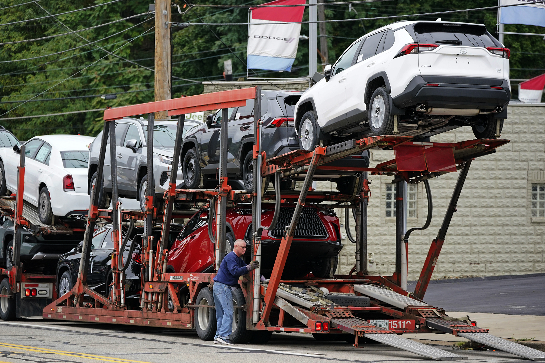 New cars are delivered to a dealer in Pittsburgh on Sept. 29. The prices of new and used vehicles in the United States have begun inching down from their eye-watering record highs as more vehicles have become gradually available at dealerships.