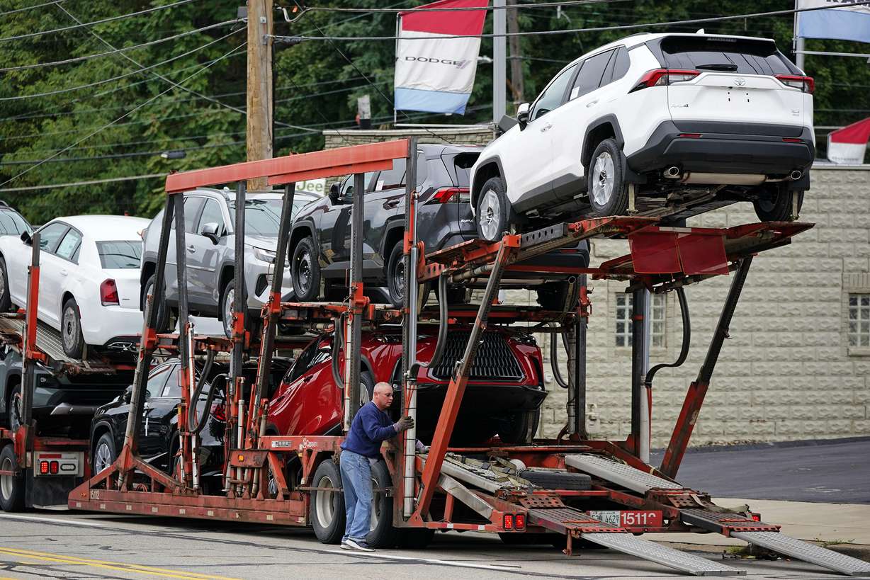 New cars are delivered to a dealer in Pittsburgh on Sept. 29. The prices of new and used vehicles in the United States have begun inching down from their eye-watering record highs as more vehicles have become gradually available at dealerships.