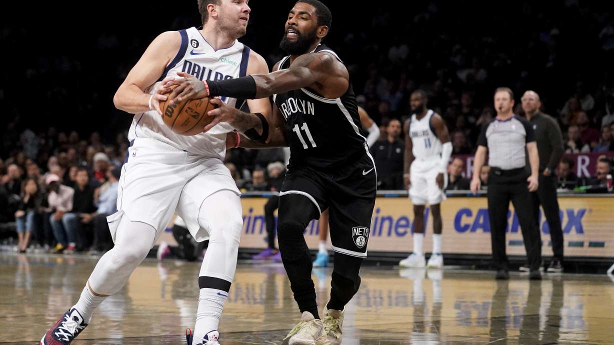Dallas Mavericks guard Luka Doncic, left, drives against Brooklyn Nets guard Kyrie Irving (11) during the first half of an NBA basketball game, Thursday, Oct. 27, 2022, in New York.