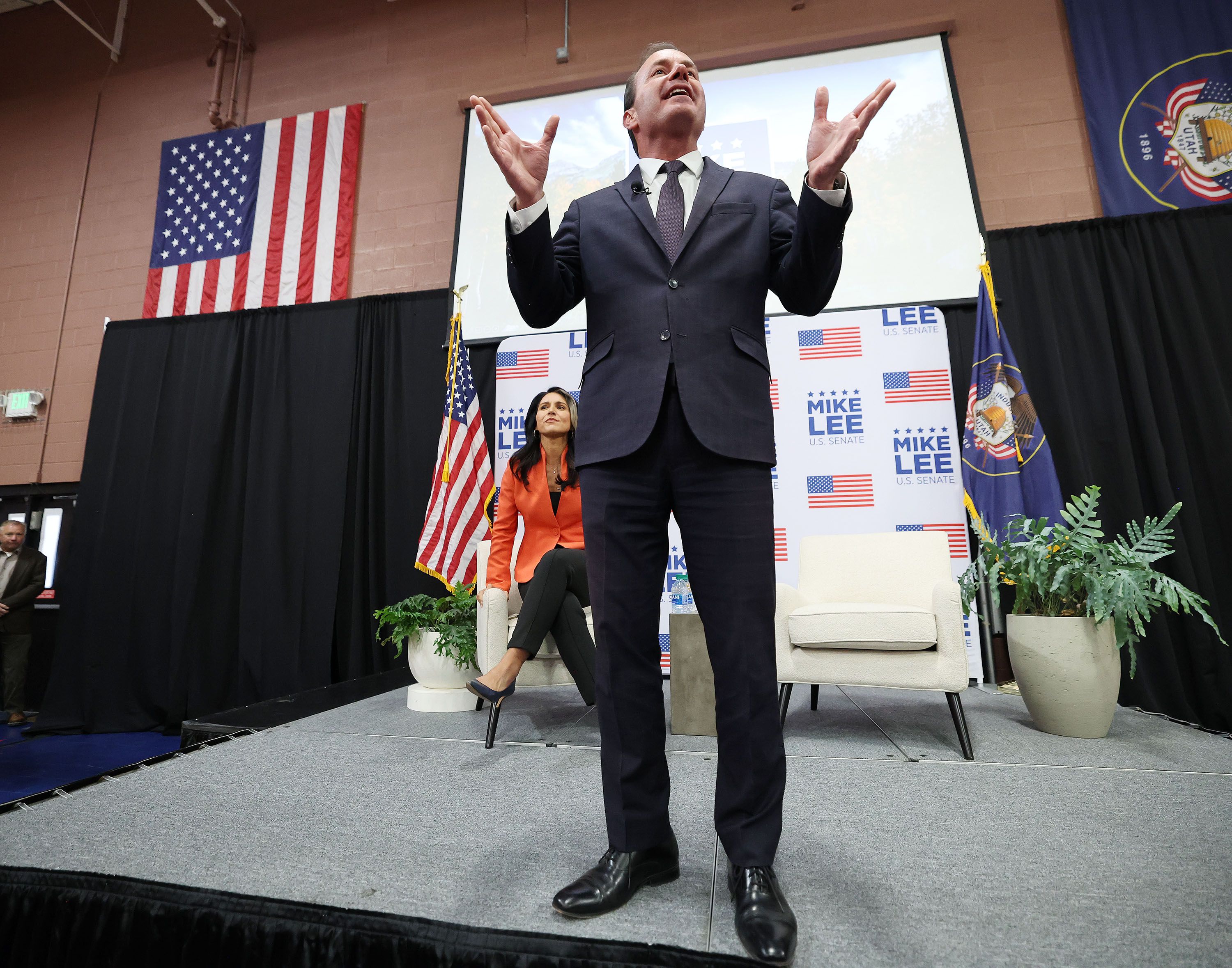 Sen. Mike Lee, R-Utah, speaks as former Democratic Rep. Tulsi Gabbard, D-Hawaii, campaigns for him during a rally at the American Preparatory Academy in Draper on Oct. 27.