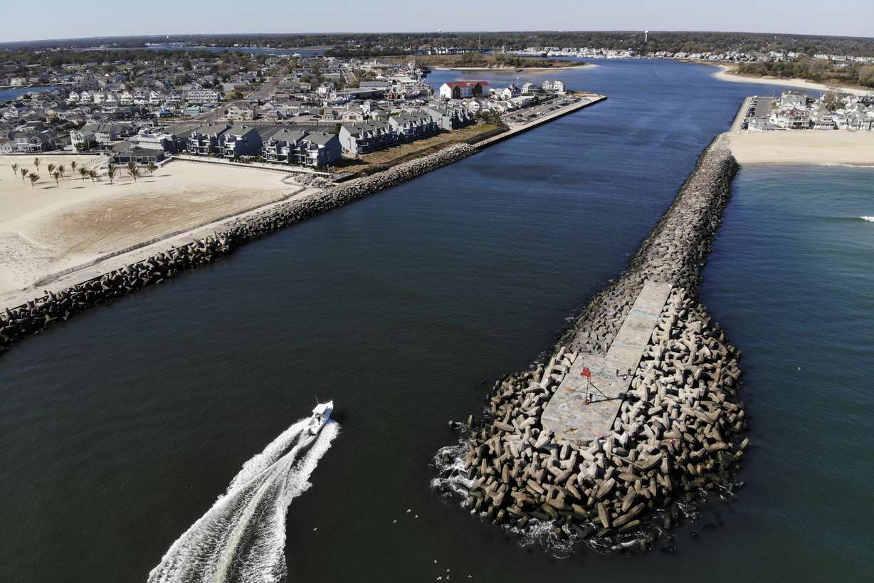 A boat enters the Manasquan Inlet in Manasquan, N.J., Oct. 20, 2022. One proposed solution to flooding is a $16 billion plan by the U.S. Army Corps of Engineers to address back-bay flooding along the Jersey Shore - a major source of damage during Sandy that was overshadowed by oceanfront flooding.