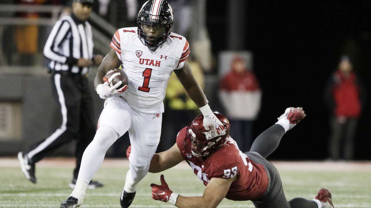 Utah running back Jaylon Glover (1) gets past Washington State defensive lineman Christian Mejia (93) during the first half of an NCAA college football game, Thursday, Oct. 27, 2022, in Pullman, Wash.