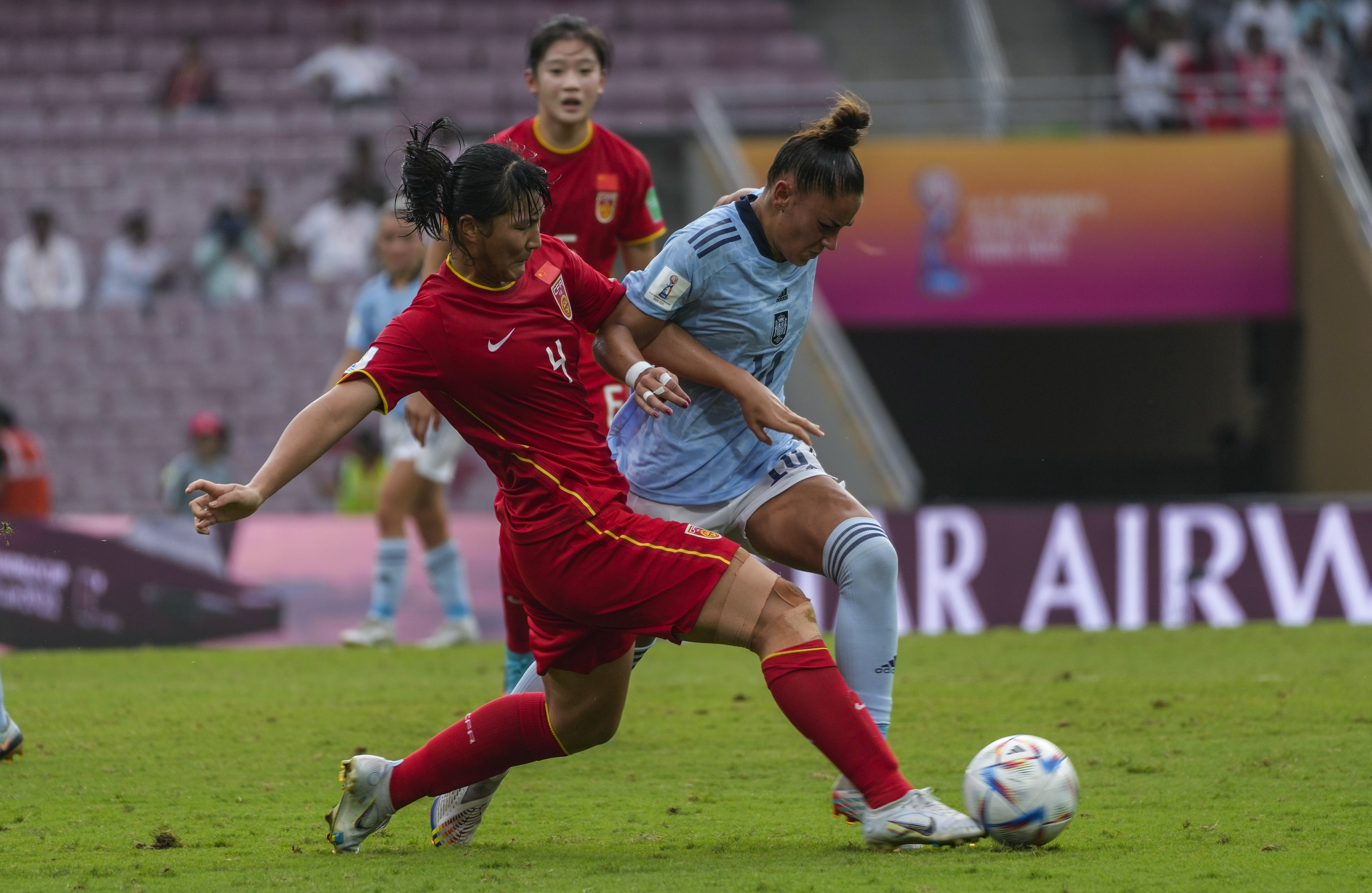 China's Huang Jiaxin, left, competes for the ball with Spain's Carla Camacho during the FIFA U-17 Women's World Cup soccer match between China and Spain in Navi Mumbai, India, Tuesday, Oct. 18, 2022. 