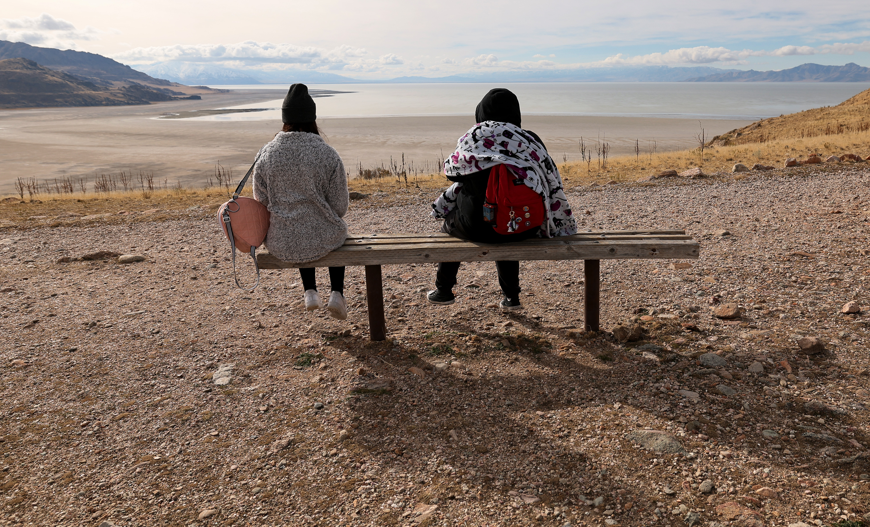 Two students sit on a bench looking out over the lake as they and other students and teachers from Horizonte High in Salt Lake City take a trip to Antelope Island to gain first hand knowledge of the situation with the low water levels and the effects on the air quality on Thursday, Oct. 27.