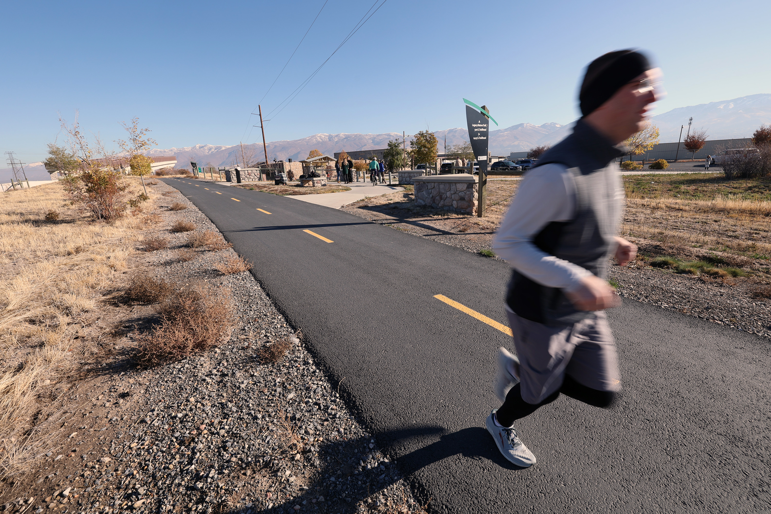 A jogger utilizes the trail as UDOT executive director Carlos Braceras joins Gov. Spencer Cox in announcing the vision for state-wide trail systems at a press conference in Woods Cross on Friday, Oct. 28, 2022.