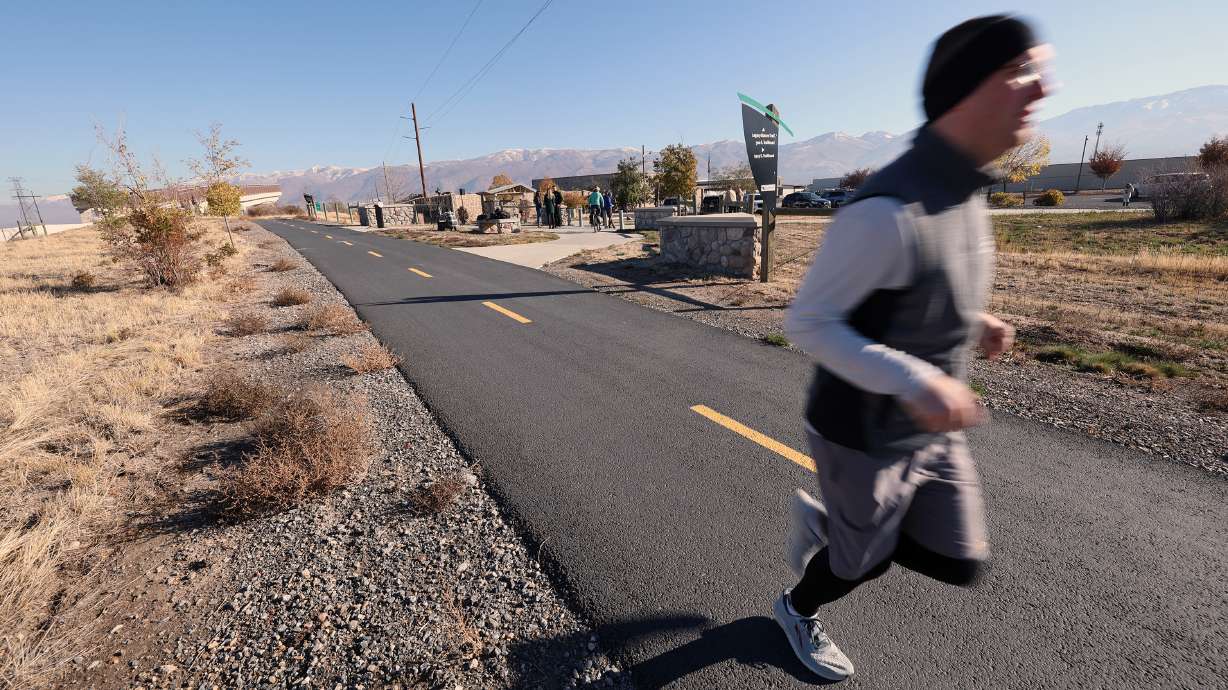 A jogger uses the Legacy Parkway Trail in Woods Cross on Oct. 28, 2022. Utah Gov. Spencer Cox signed a bill last week that sets up the framework and initial funding needed to begin a statewide trail system.