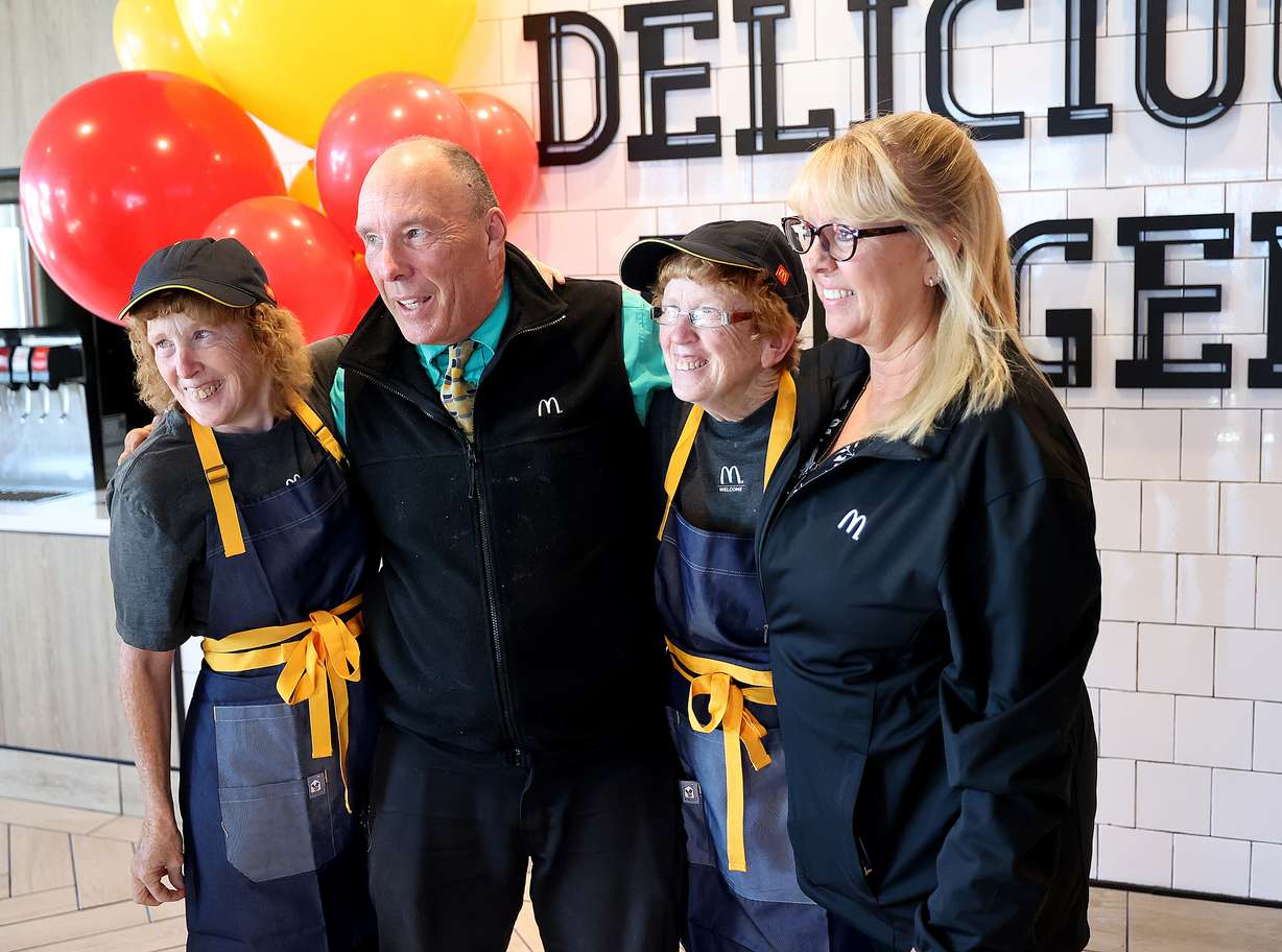 Ellen and Elaine Hamilton, who have worked at McDonald's for 40 years, pose for photos with Ron Nielsen, a general manager, and his wife, Tawna Nielsen, an area supervisor, after the sisters were recognized for their service in Salt Lake City on Friday.