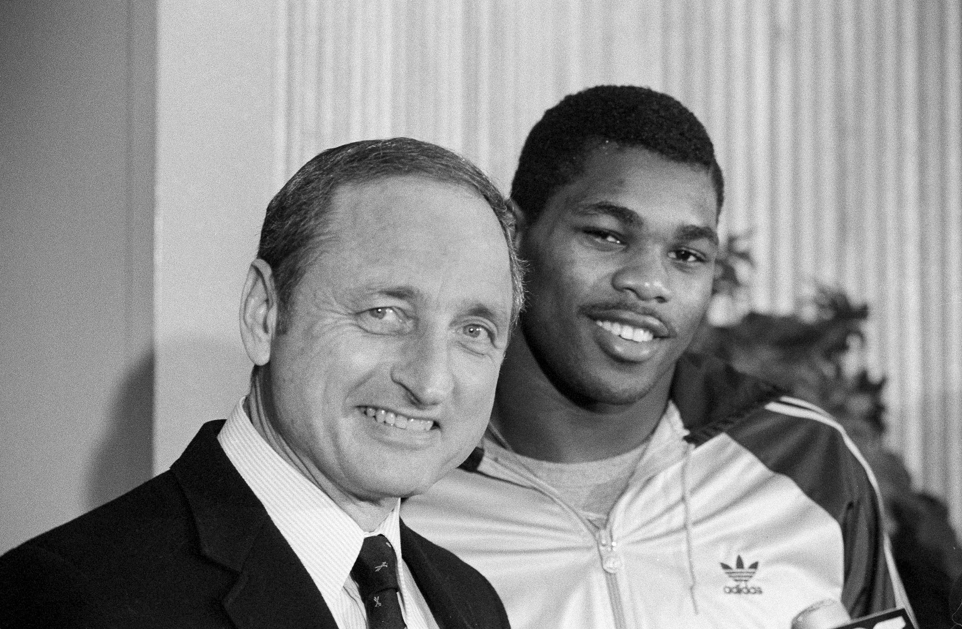 FILE - Georgia running back Herschel Walker, right, brings a smile to the face of his coach Vince Dooley as he announces that he would play football next year at Georgia rather than the USFL, Feb. 8, 1983 in Athens, Ga. Vince Dooley, the football coach who carried himself like a professor and guided Georgia for a quarter-century of success that included the 1980 national championship, died Friday, Oct. 28, 2022. He was 90.