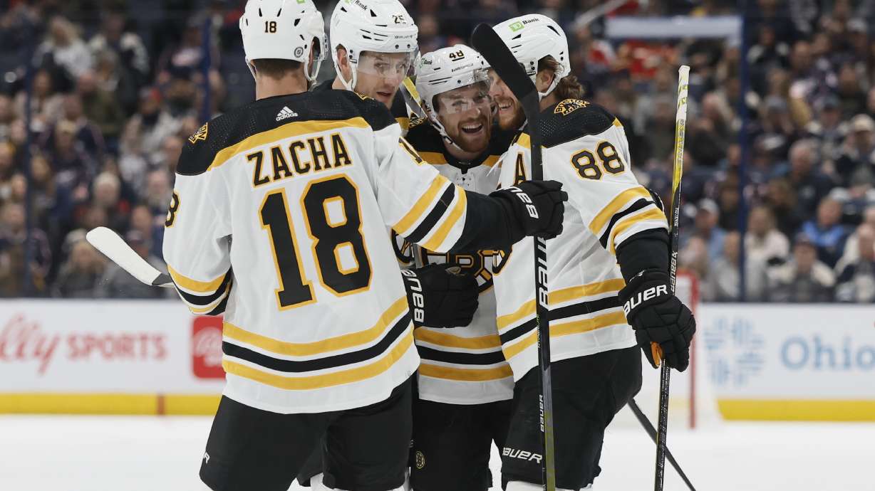 Boston Bruins' Matt Grzelcyk, second from right, celebrates with teammates after his goal against the Columbus Blue Jackets during the first period of an NHL hockey game Friday, Oct. 28, 2022, in Columbus, Ohio.