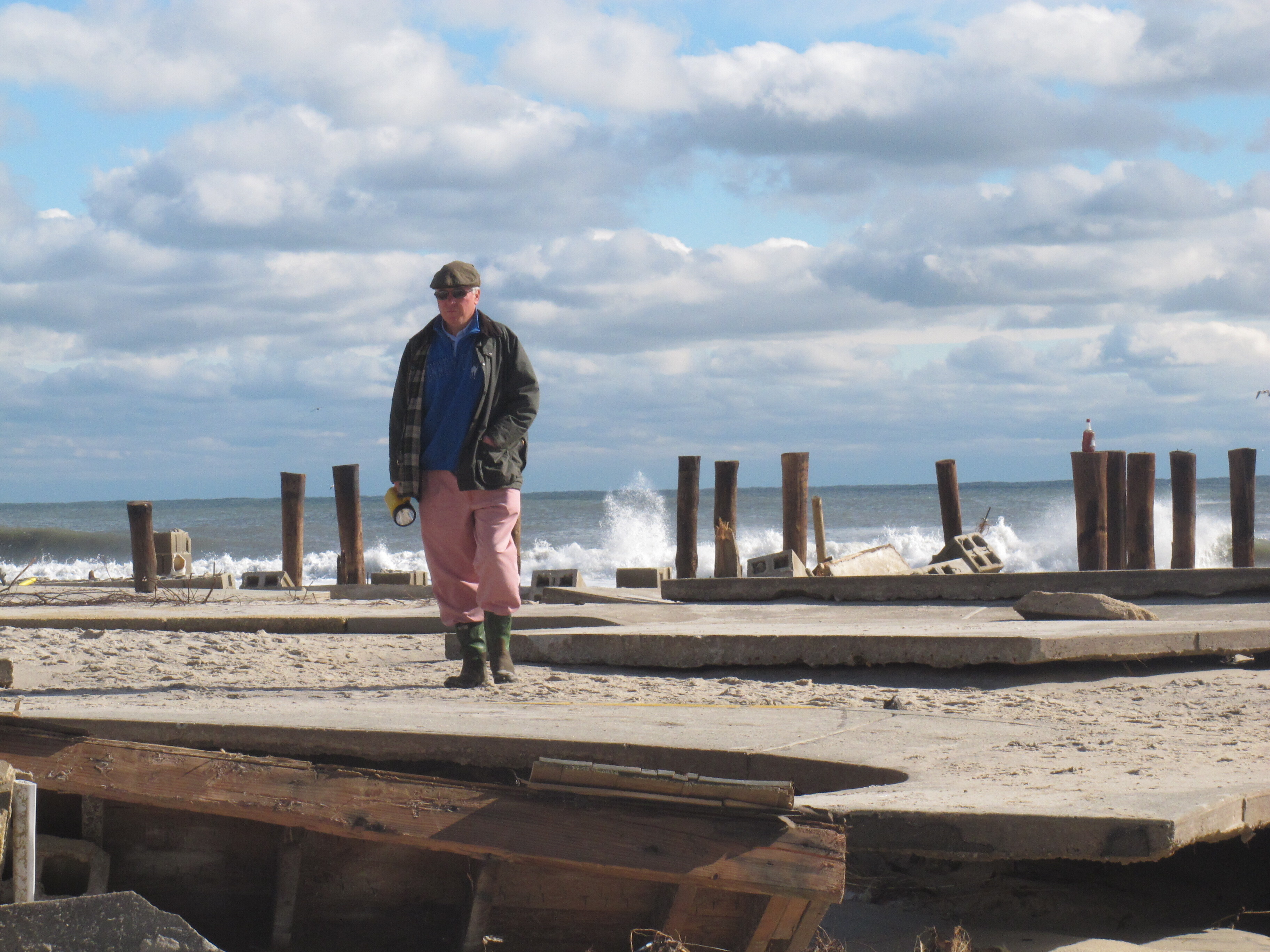In this Oct. 31, 2012, photo, Peter Green surveys the wreckage of an oceanfront home in Bay Head, N.J., two days after Superstorm Sandy hit. Ten years later, government officials and residents say much has been done to prepare for future storms but caution that much more still remains to be done in an era of rising sea levels and a changing climate. 