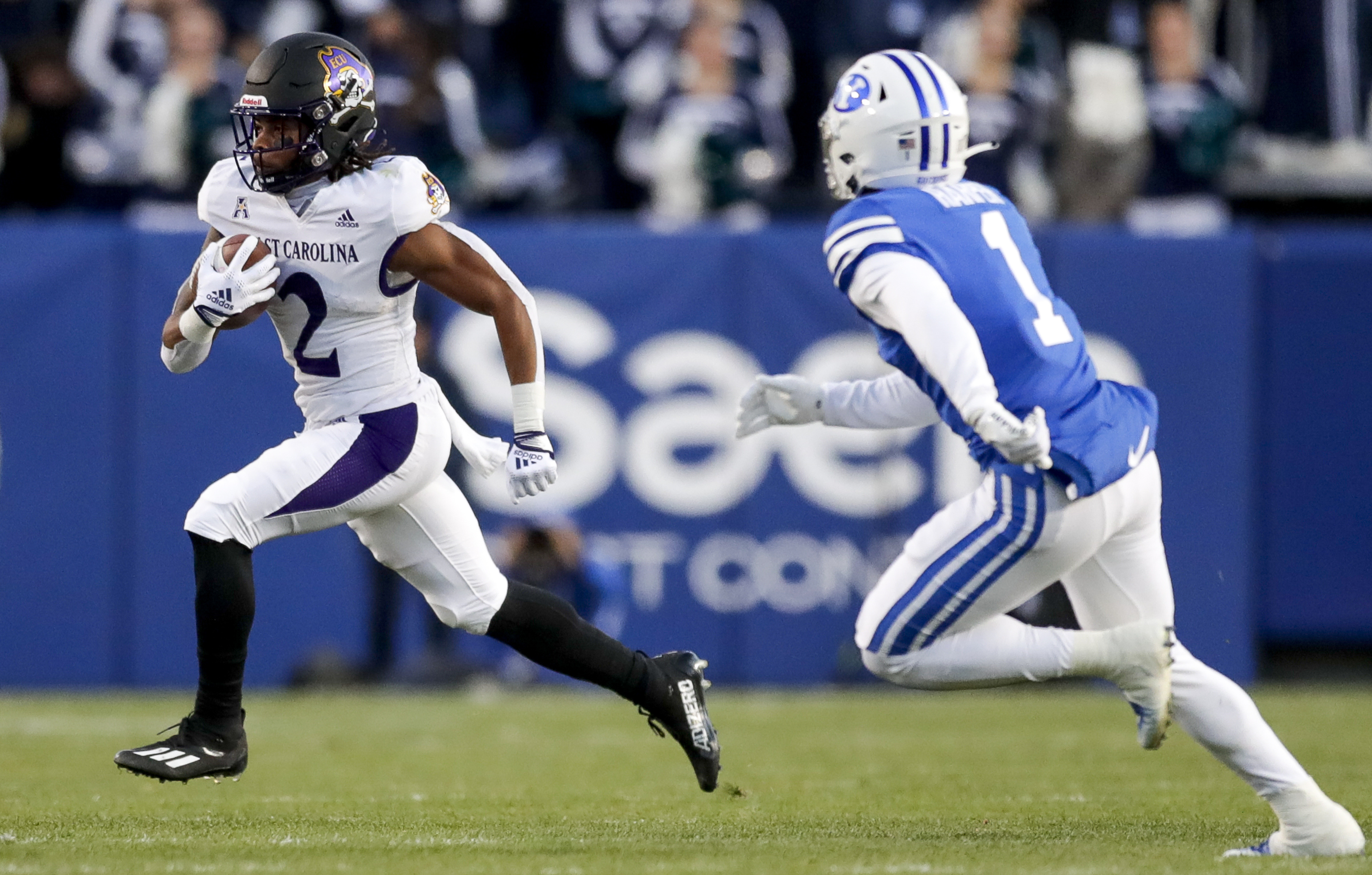 East Carolina running back Keaton Mitchell (2) runs the ball while avoiding BYU’s Micah Harper (1) during a NCAA college football game Friday, Oct. 28, 2022, in Provo. The Pirates won 27-24.