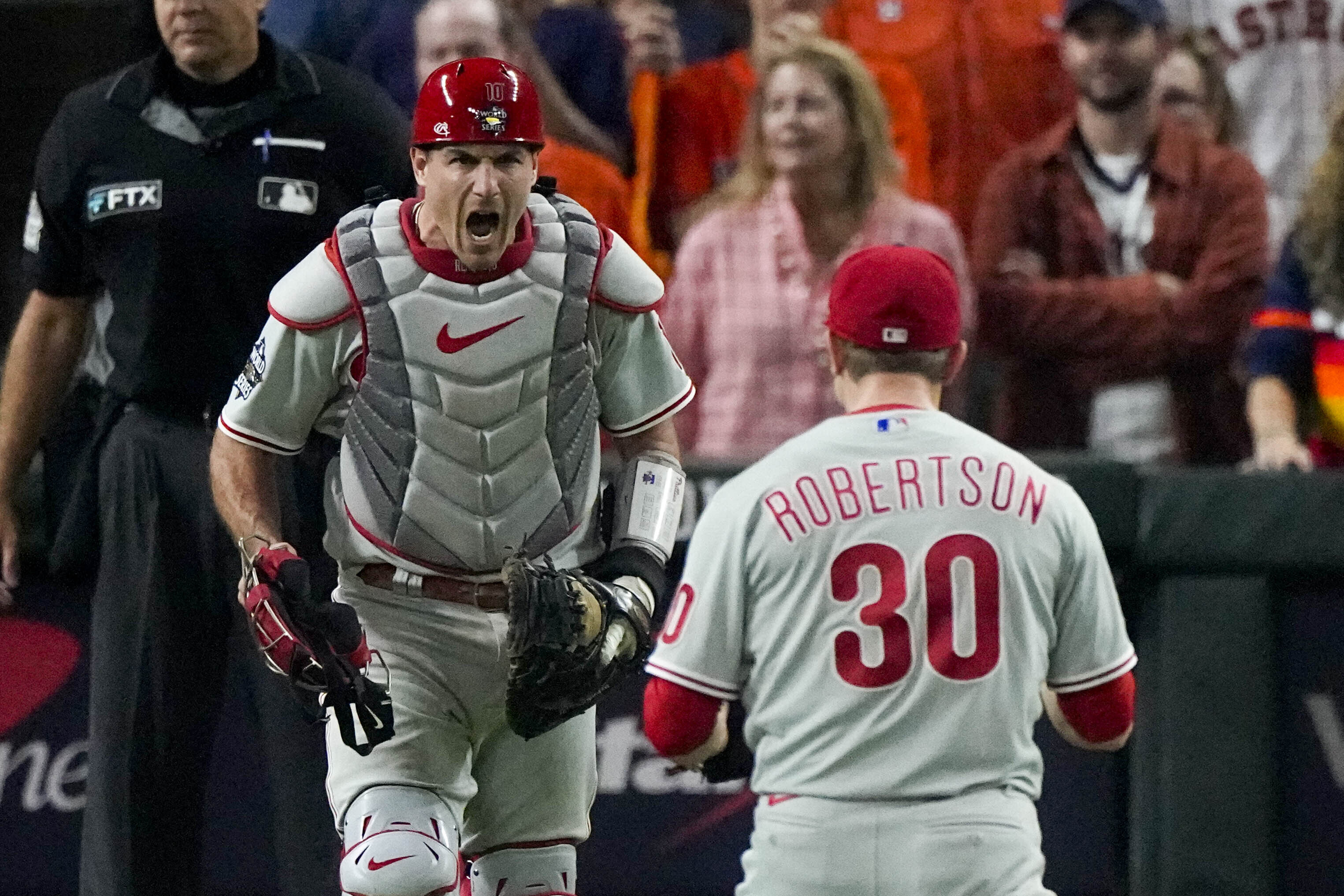 Philadelphia Phillies relief pitcher David Robertson and catcher J.T. Realmuto celebrate after their win against the Houston Astros in Game 1 of baseball's World Series between the Houston Astros and the Philadelphia Phillies on Friday, Oct. 28, 2022, in Houston. The Phillies won 6-5 to take a one game lead in the series. 