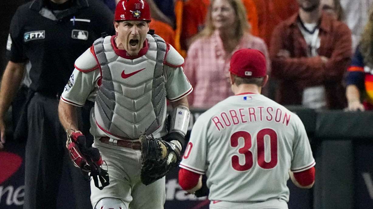 Philadelphia Phillies relief pitcher David Robertson and catcher J.T. Realmuto celebrate after their win against the Houston Astros in Game 1 of baseball's World Series between the Houston Astros and the Philadelphia Phillies on Friday, Oct. 28, 2022, in Houston. The Phillies won 6-5 to take a one game lead in the series.
