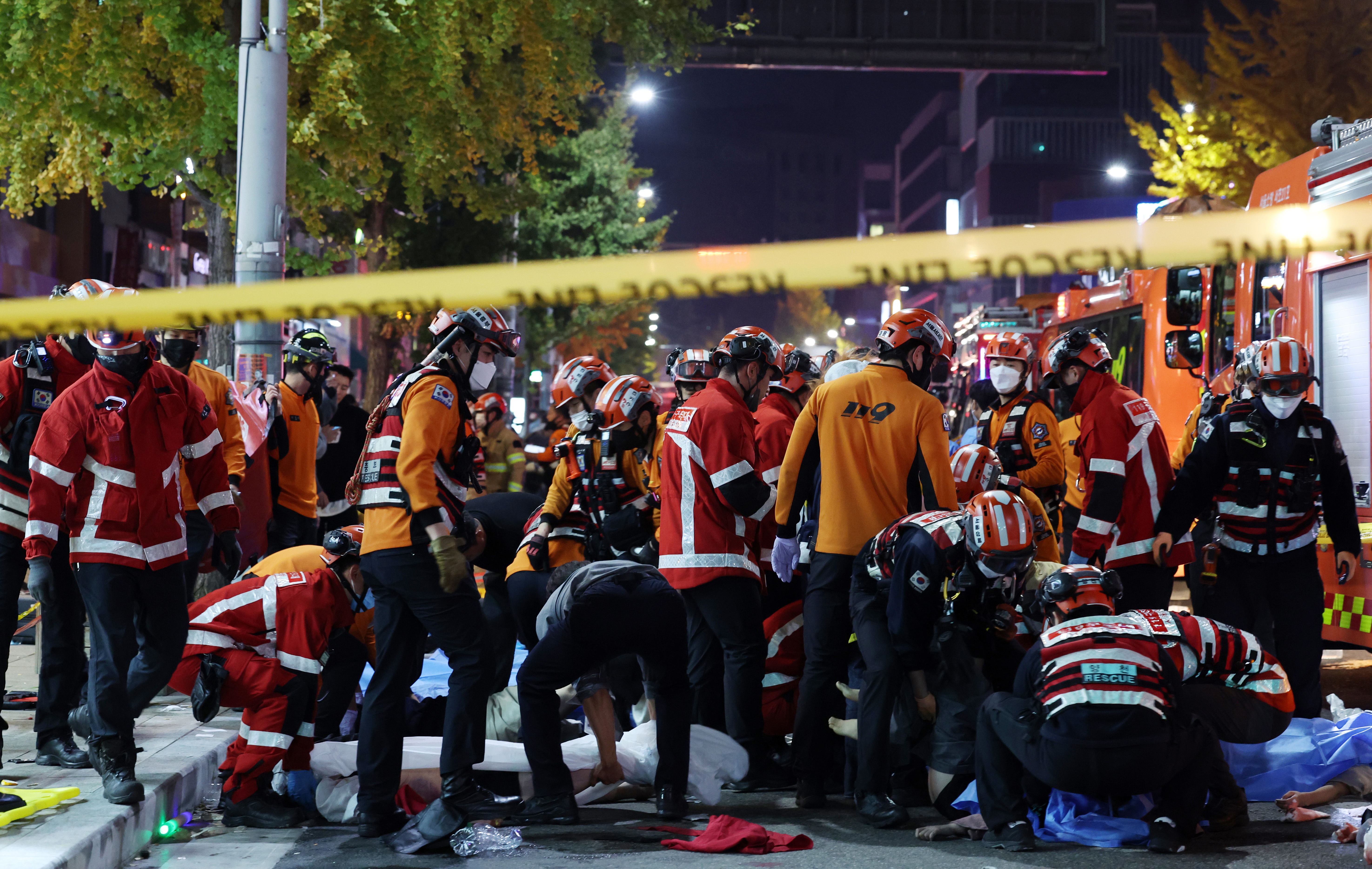 Rescue workers and firefighters work on the scene of a crushing accident in Seoul, South Korea, Saturday. A mass of mostly young people celebrating Halloween festivities in Seoul became trapped and crushed as the crowd surged into a narrow alley, killing at least 149 people and injuring 150 others in South Korea's worst disaster in years.