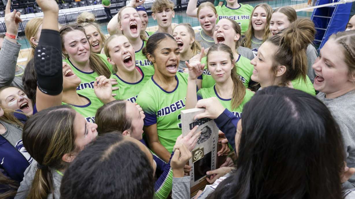 The Ridgeline Riverhawks storm and celebrate on the court after beating the Desert Hills Thunder in the 4A volleyball state championship in Orem on Saturday, Oct. 29, 2022. The Riverhawks won in straight sets for their repeat title.