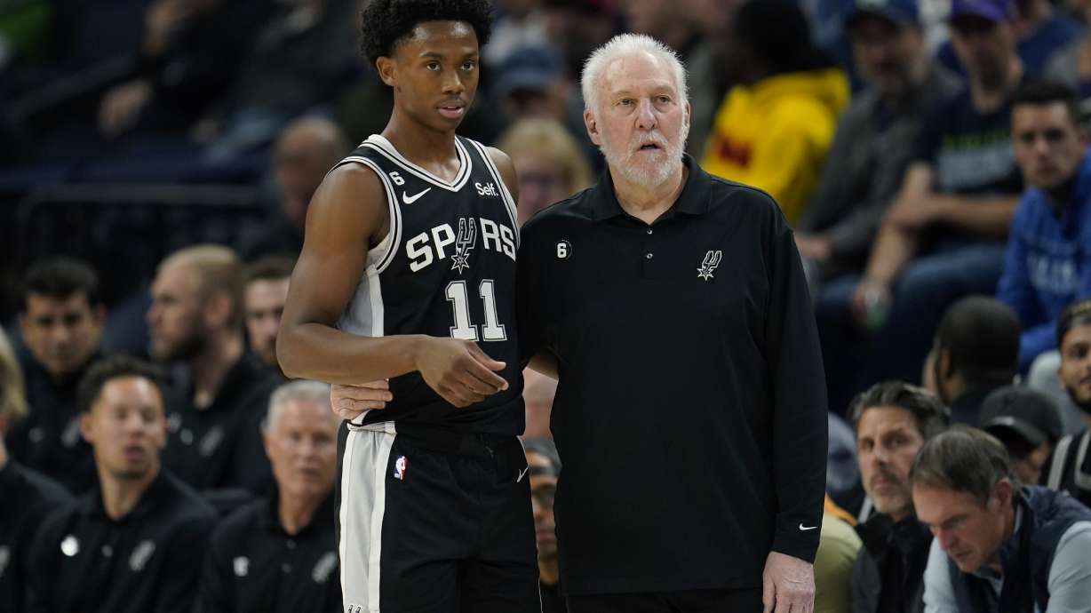 San Antonio Spurs guard Joshua Primo (11) and head coach Gregg Popovich watch play during the first half of an NBA basketball game against the Minnesota Timberwolves, Monday, Oct. 24, 2022, in Minneapolis.