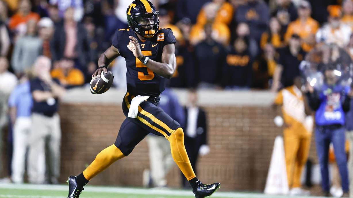 Tennessee quarterback Hendon Hooker (5) rolls out to pass during the first half of an NCAA college football game against Kentucky, Saturday, Oct. 29, 2022, in Knoxville, Tenn.