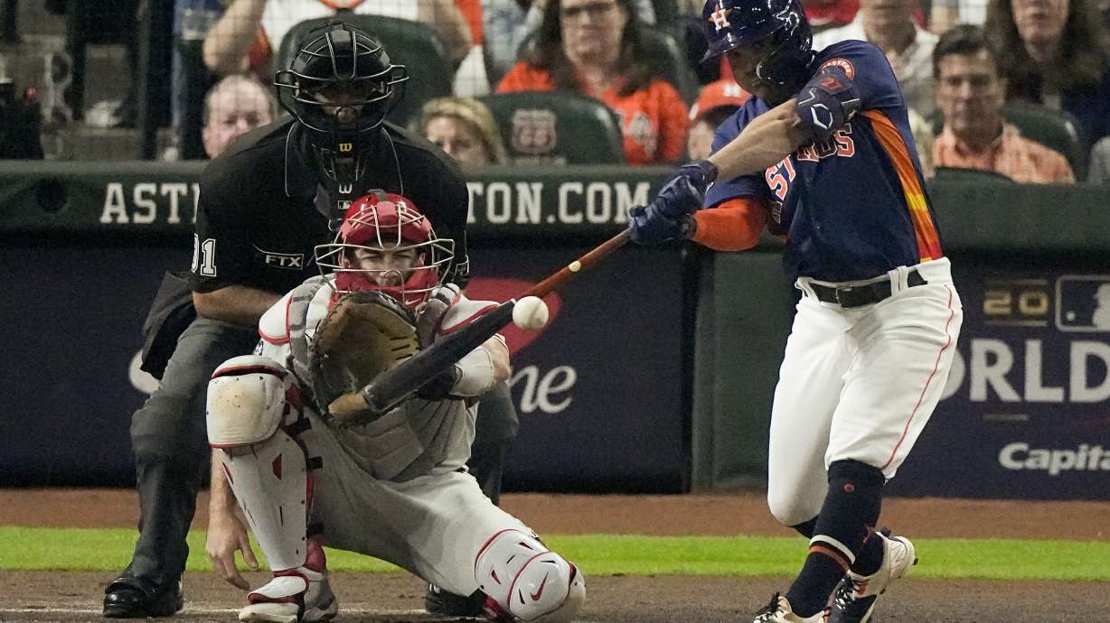 Houston Astros' Jose Altuve hits a double during the first inning in Game 2 of baseball's World Series between the Houston Astros and the Philadelphia Phillies on Saturday, Oct. 29, 2022, in Houston.