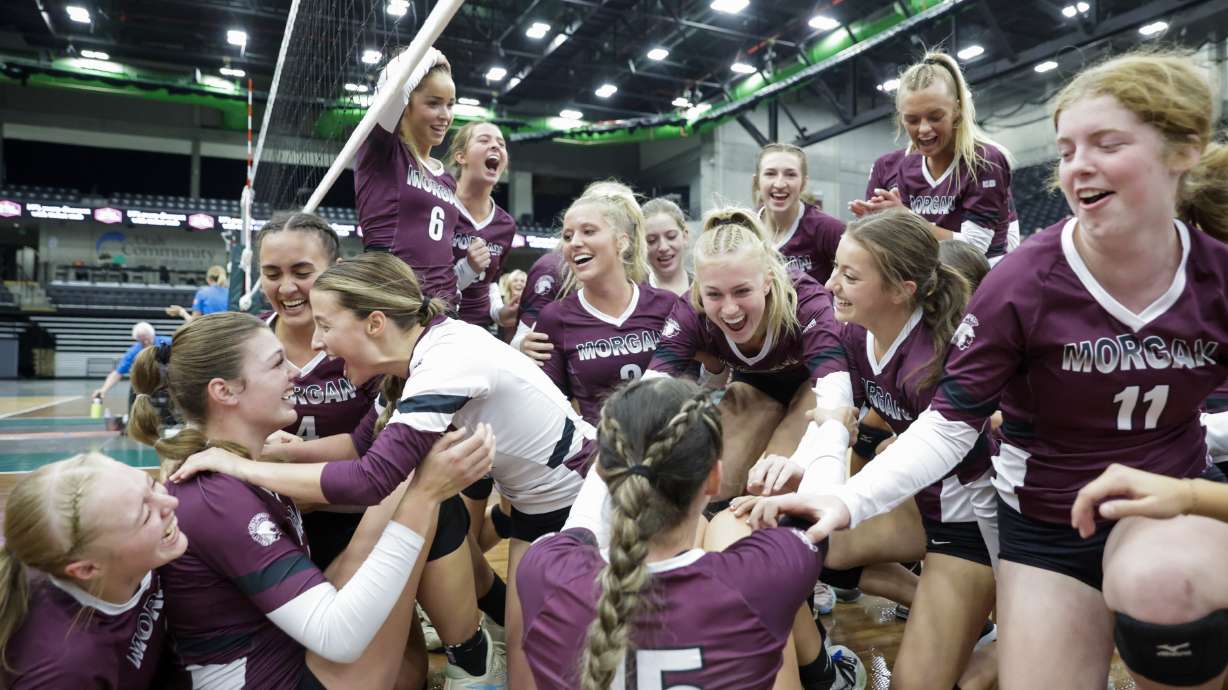 The Morgan Trojans storm and celebrate on the court after beating the Richfield Wildcats in the 3A state volleyball tournament in Orem on Saturday, Oct. 29, 2022. The Trojans won 3-1.