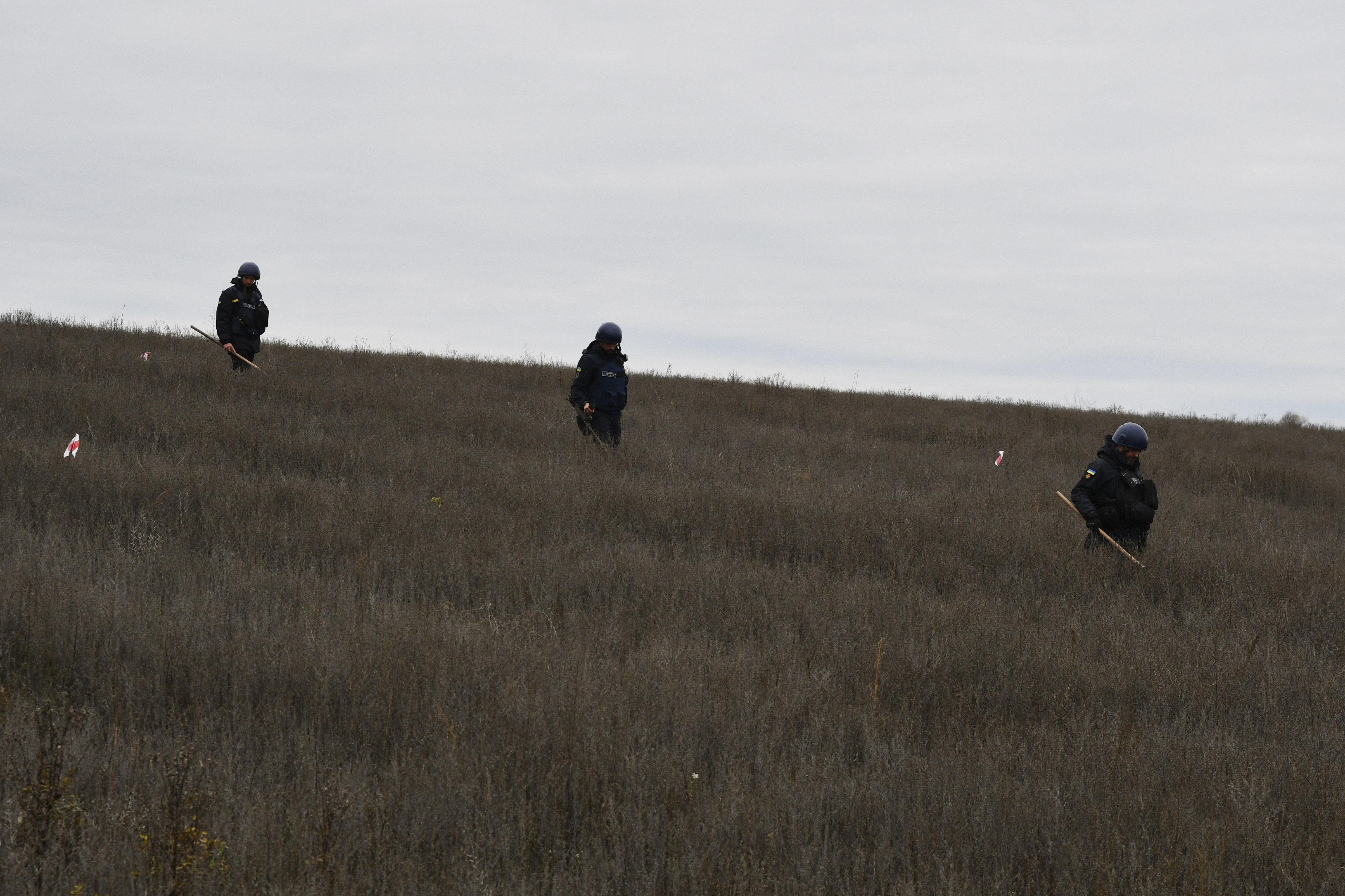 Ukrainian servicemen check for explosives outside the liberated town of Sviatohirsk, Donetsk region, Ukraine, Saturday.
