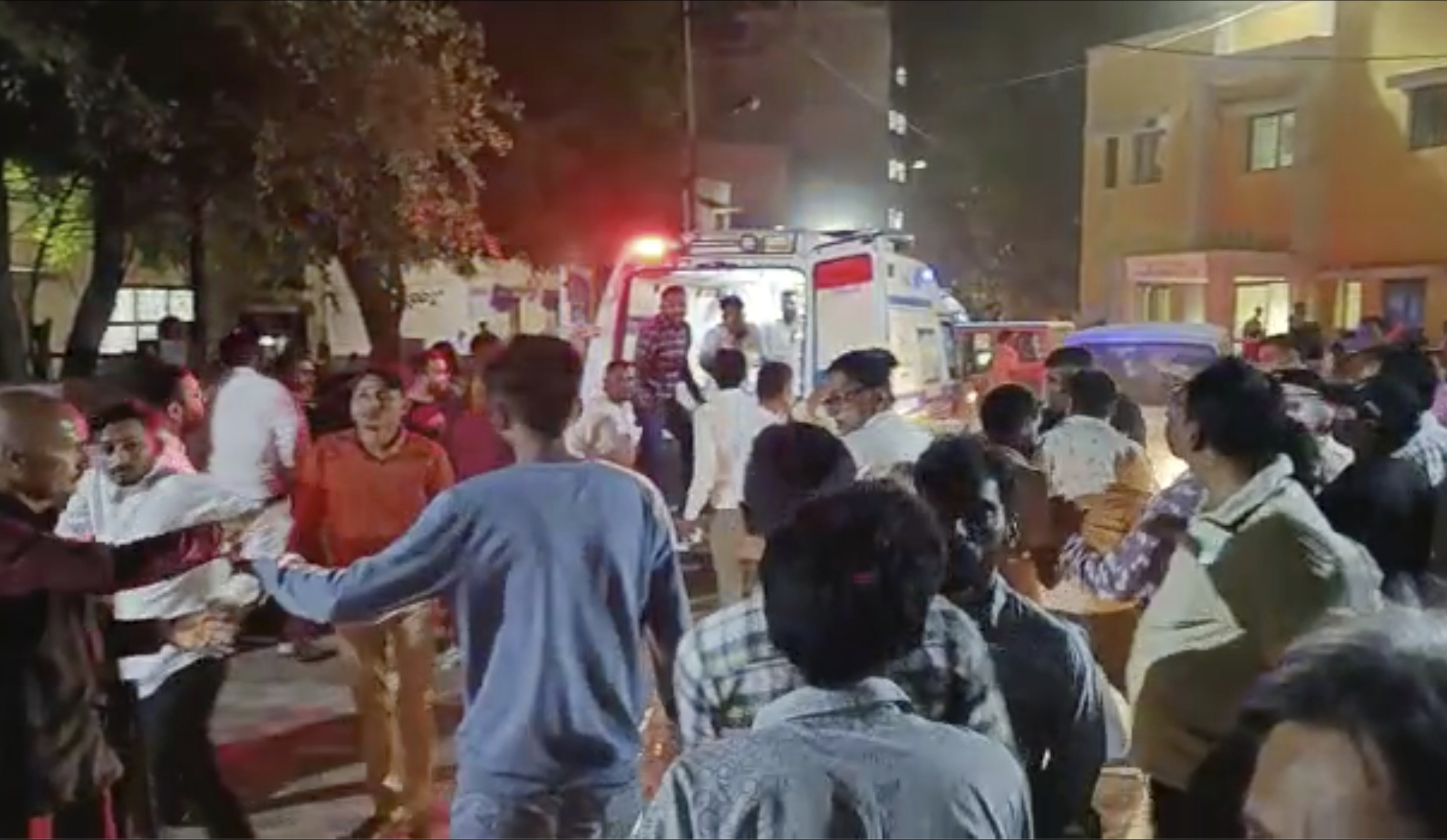 This image from video shows the commotion outside a hospital where victims of a cable bridge collapse are being rushed in for treatment in Morbi district, western Gujarat state, India, Sunday. Dozens are feared dead and several injured when a cable bridge across the Machchu river collapsed Sunday. 