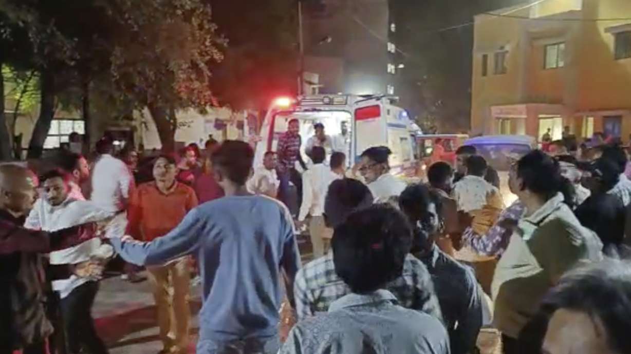 This image from video shows the commotion outside a hospital where victims of a cable bridge collapse are being rushed in for treatment in Morbi district, western Gujarat state, India, Sunday. Dozens are feared dead and several injured when a cable bridge across the Machchu river collapsed Sunday.