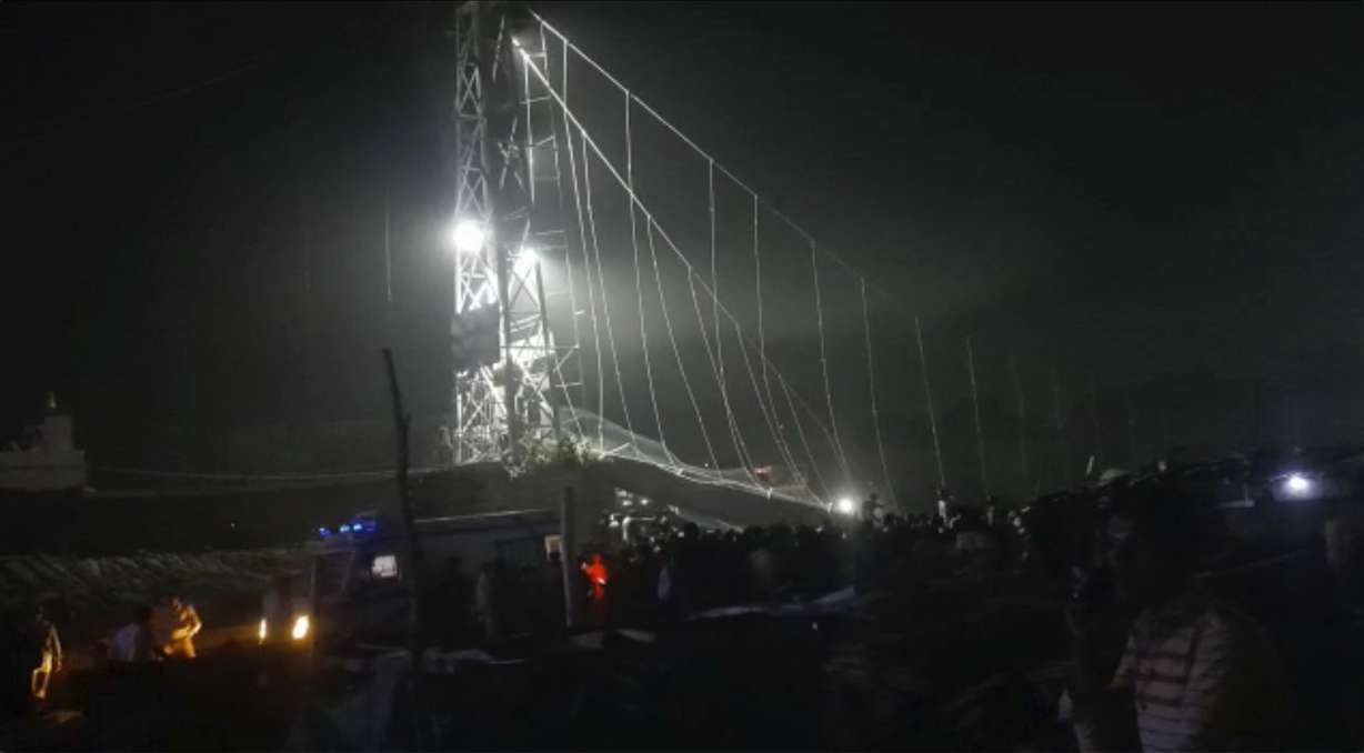 Rescuers work at night after a cable bridge across the Machchu river collapsed in Morbi district, western Gujarat state, India, Sunday. Dozens are dead and many are feared injured in the accident.