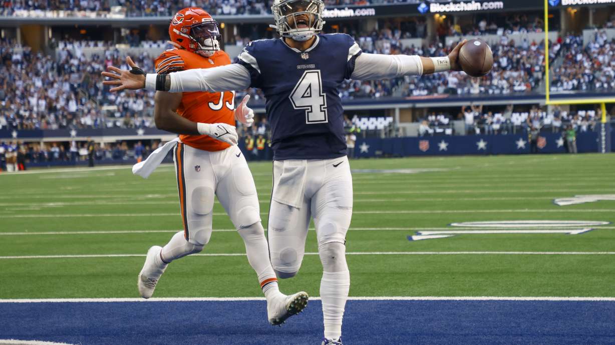 Dallas Cowboys' Dak Prescott runs for a touchdown during the first half of an NFL football game against the Chicago Bears Sunday, Oct. 30, 2022, in Arlington, Texas.