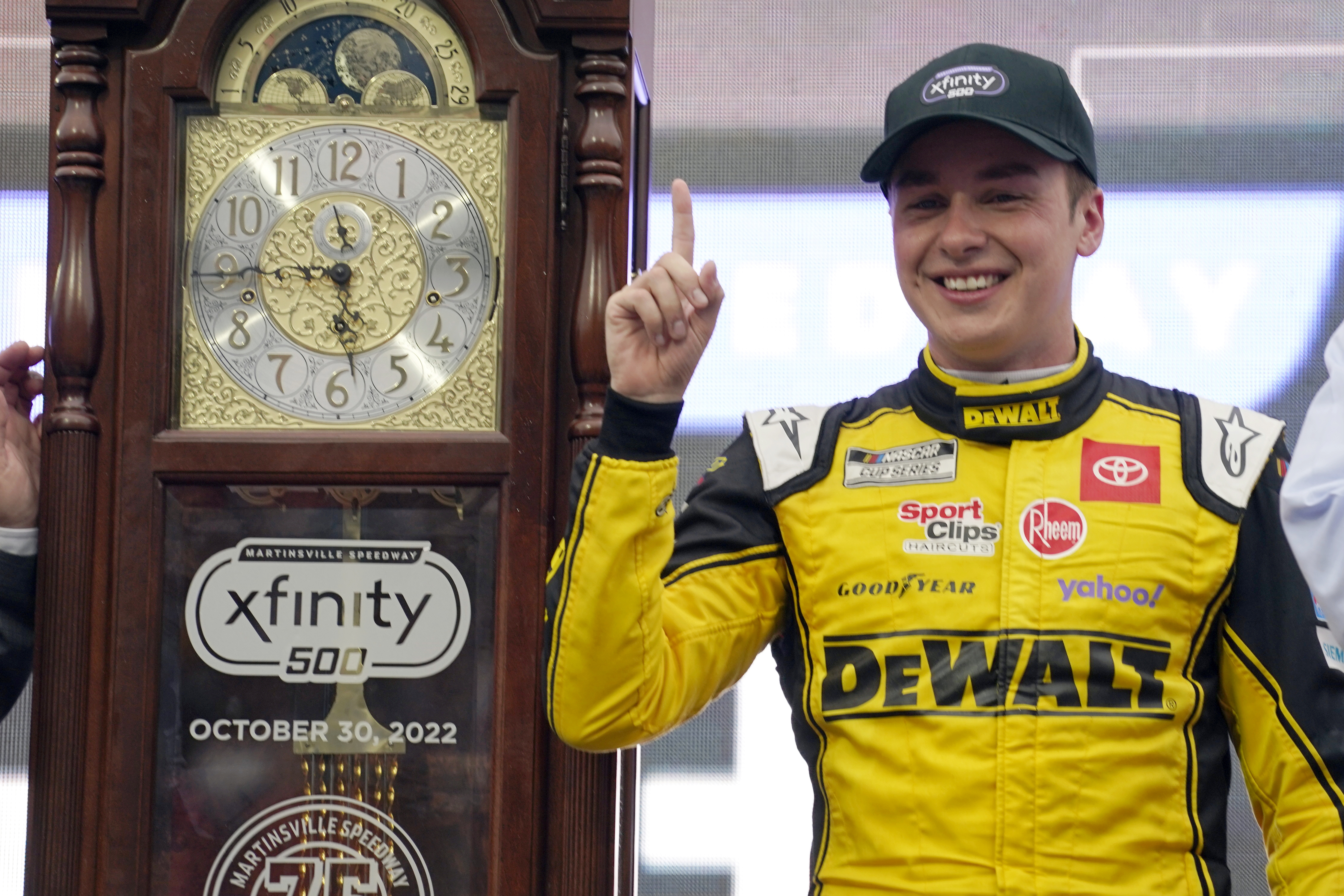 Christopher Bell (20) poses with the trophy in Victory Lane after winning a NASCAR Cup Series auto race at Martinsville Speedway, Sunday, Oct. 30, 2022, in Martinsville, Va. 