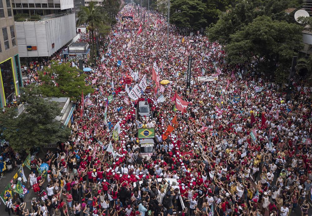 Supporters gather round a vehicle carrying former Brazilian President Luiz Inacio Lula da Silva during a campaign rally in Sao Paulo, Brazil, Saturday. On Sunday, Brazilians went to the voting booth again to choose between da Silva and incumbent Jair Bolsonaro, who are facing each other in a runoff vote after neither got enough support to win outright in the Oct. 2 general election.