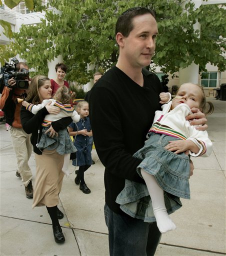 Jake and Erin Herrin carry their formerly conjoined twins Kendra and Maliyah, right, out of Primary Children's Medical Center before heading for home Sunday, Sept. 17, 2006, in Salt Lake City. The two 4-year-old girls were separated last month. (AP Photo/Douglas C. Pizac)