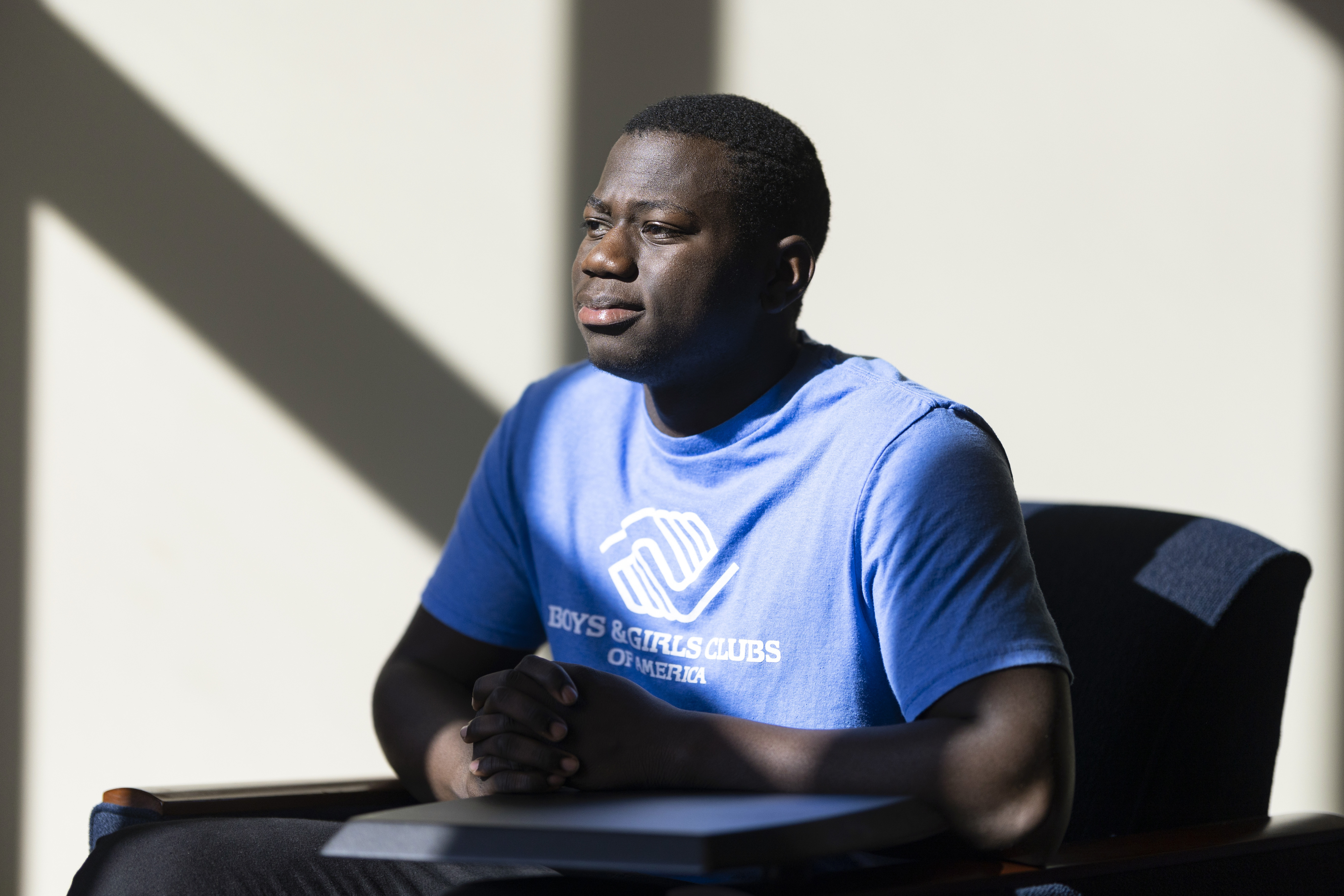Steeve Biondolillo sits for a portrait on campus at Northwest Nazarene University in Nampa, Idaho, on Oct. 7. With an early childhood in Haiti marked by poverty and other trauma, 19-year-old Biondolillo seems to have beat long odds. 