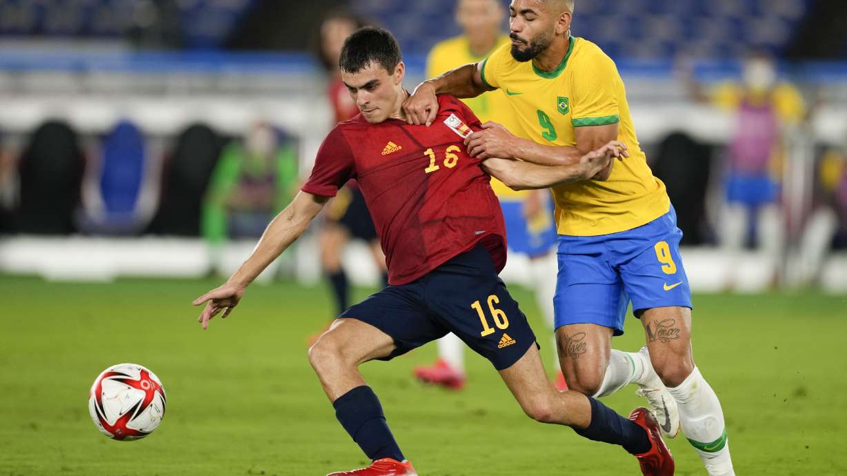 FILE - Spain's Pedri Gonzalez, left, and Brazil's Matheus Cunha battle for the ball during the men's final soccer match at the 2020 Summer Olympics, Saturday, Aug. 7, 2021, in Yokohama, Japan.