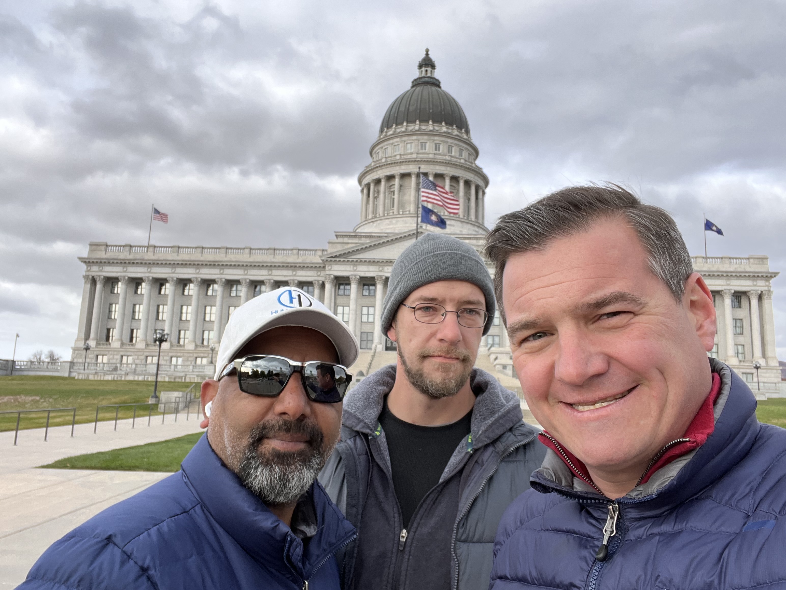 Zubih Rauf, left, James Powers, center, and Matt Zeller in front of the state Capitol in Salt Lake City. They are traveling the country garnering support for the Afghan Adjustment Act — legislation that would establish a pathway to permanent residency for thousands of Afghan humanitarian parolees.