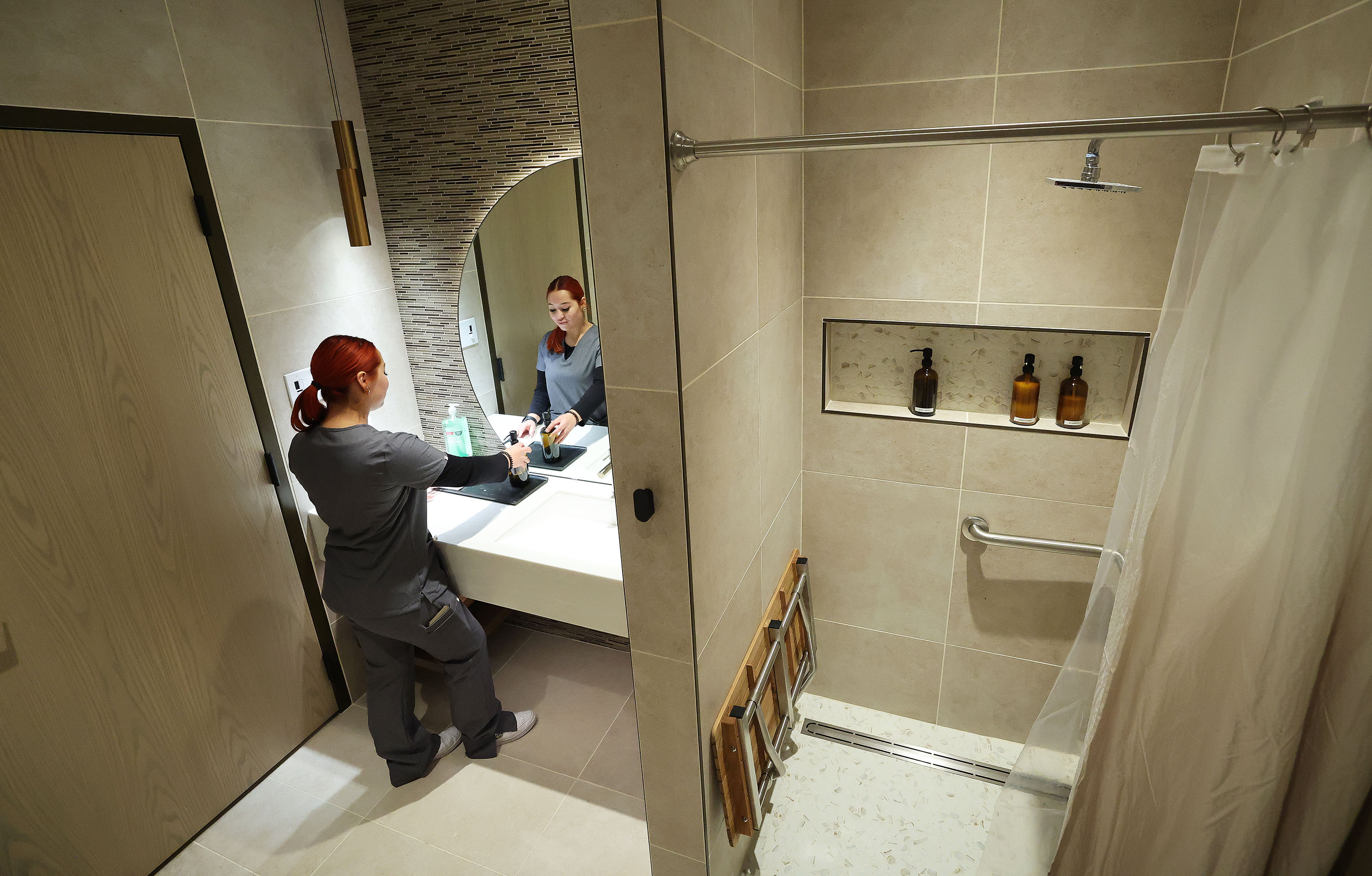 Treat medical assistant Nicolle Ortiz prepares the shower for passengers to use at the upscale health and wellness center now open at the Salt Lake City International Airport in Salt Lake City on Wednesday. The airport is the third, nationwide, to open a Treat location.