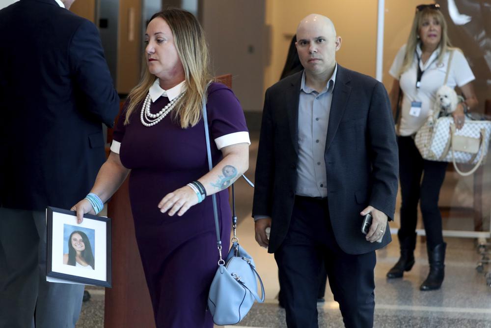 Lori Alhadeff, holding a photo of her daughter Alyssa, and her husband Ilan Alhadeff walk into court during the sentencing hearing for Marjory Stoneman Douglas High School shooter Nikolas Cruz at the Broward County Courthouse in Fort Lauderdale, Fla., on Wednesday. Cruz was sentenced to life in prison for murdering 17 people at Parkland's Marjory Stoneman Douglas High School more than four years ago.