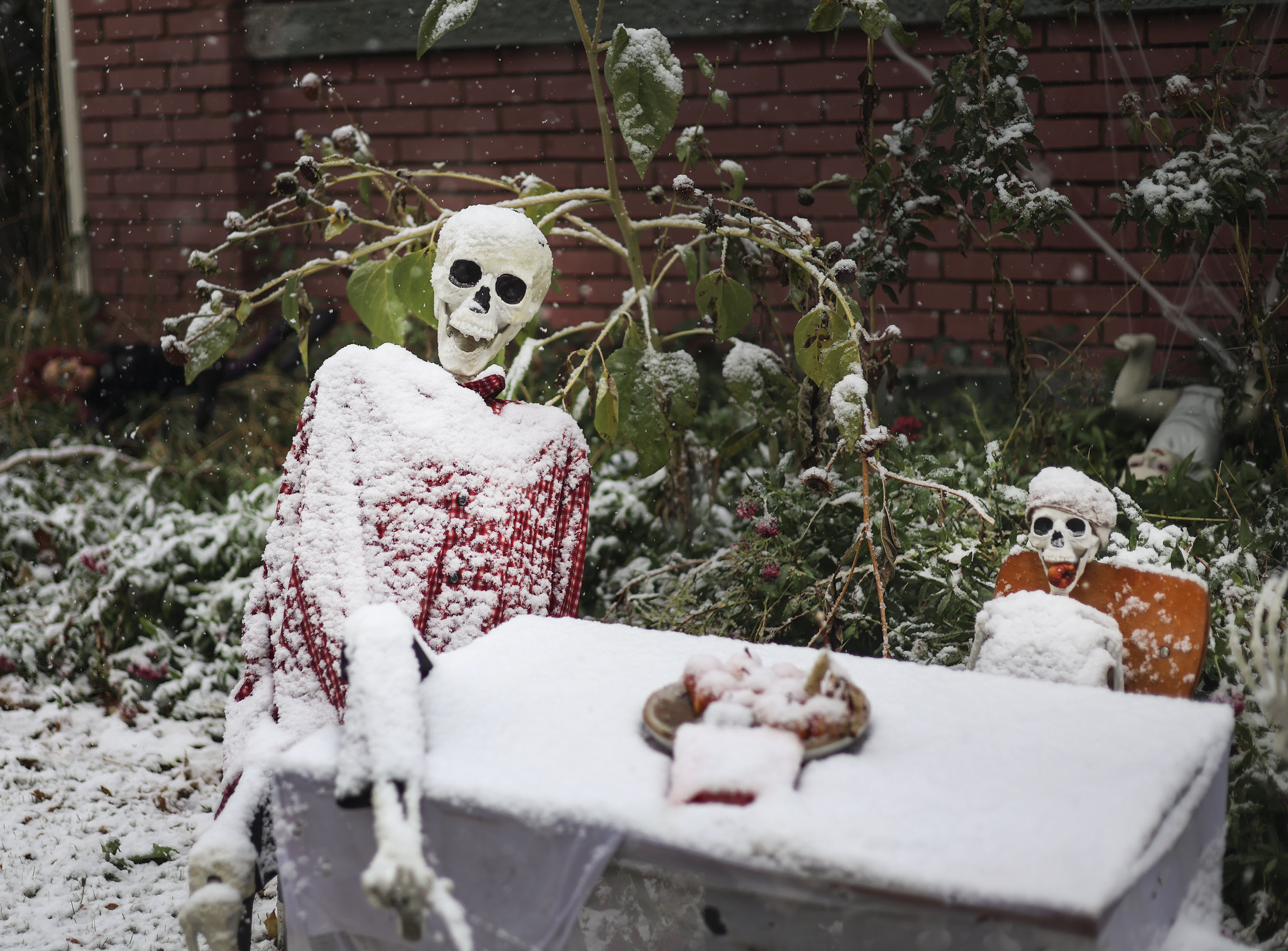 Halloween decorations are covered in snow at a home in Salt Lake City on Wednesday.