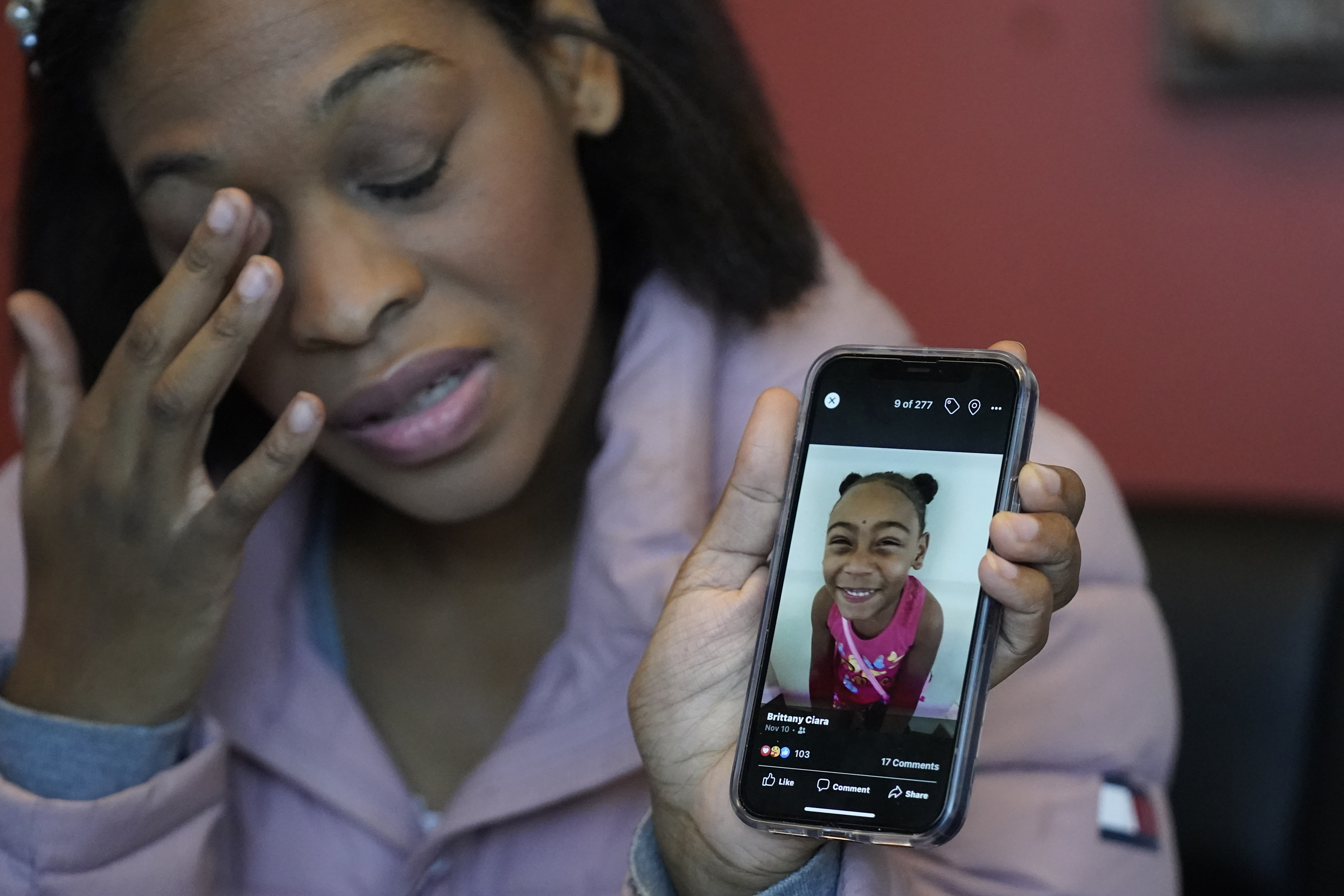 Brittany Tichenor-Cox, holds a photo of her daughter, Isabella "Izzy" Tichenor, during an interview during an interview on Nov. 29, 2021, in Draper. The family of a Black fifth grader in Utah who died by suicide last year plans to file a $14 million lawsuit against her school, arguing that an inadequate response to reports of her being bullied over her race and disabilities led to her death by suicide.