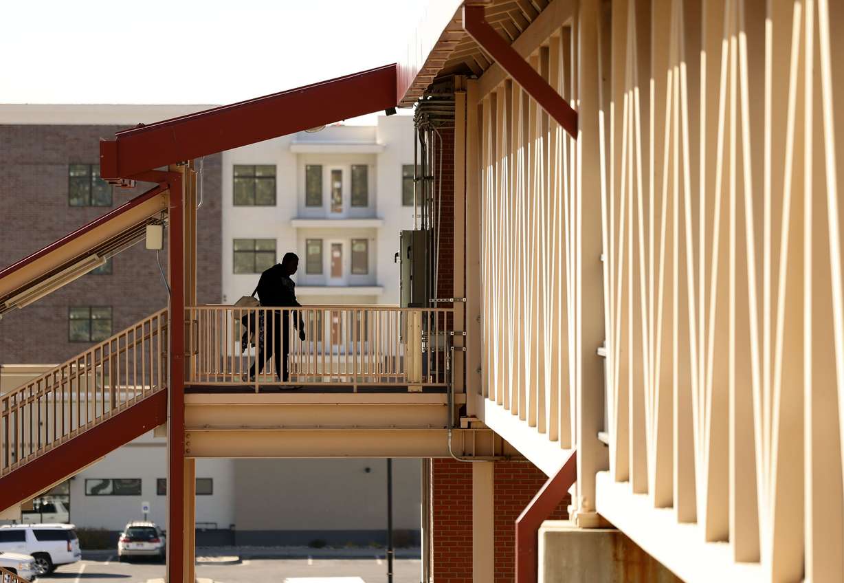 A man walks to his train at Station Park in Farmington on Oct. 31. A view of Bri at Station Park, a residential development, is pictured behind him.