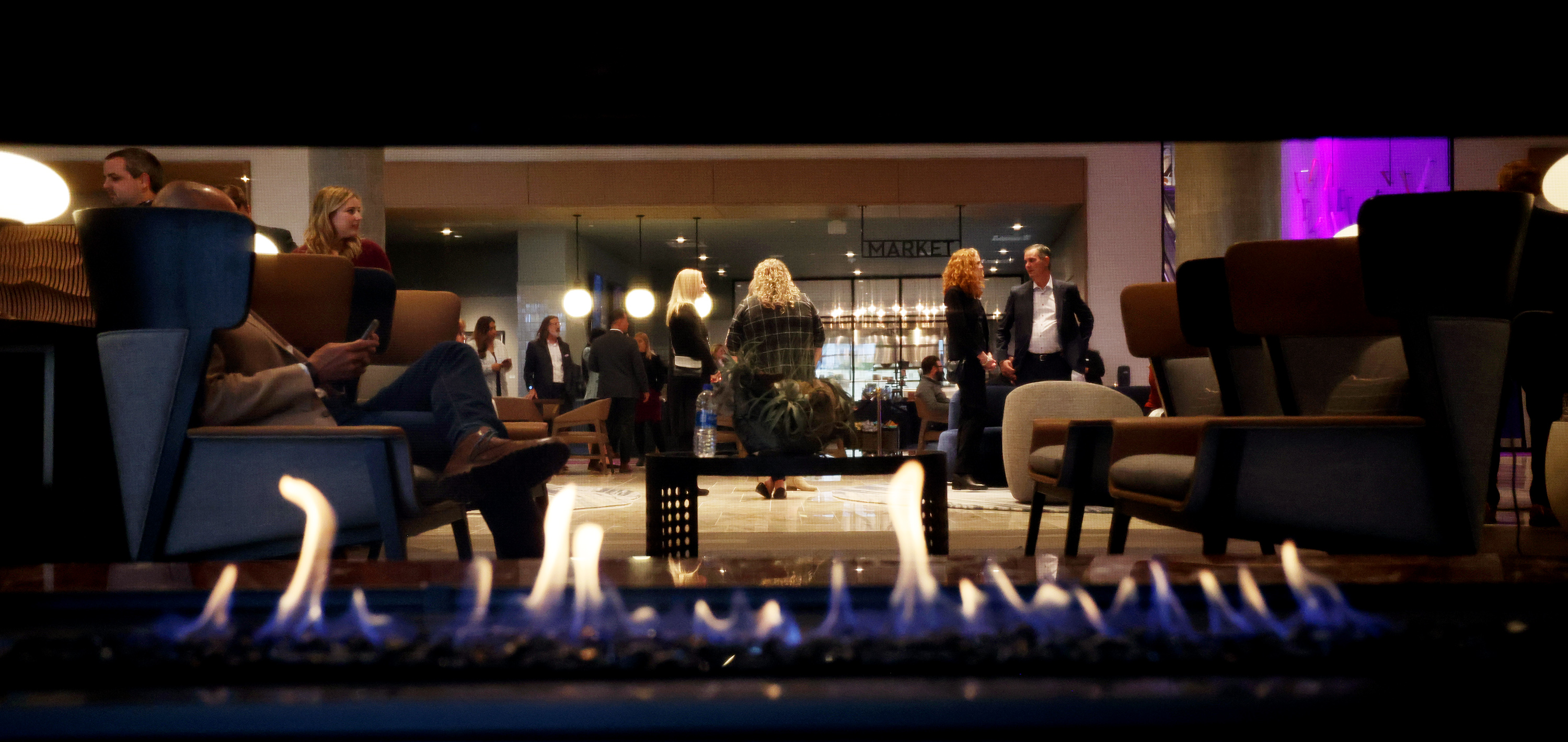 A fire burns in a sitting area fireplace near the check-in desks at the newly opened Hyatt Regency hotel in Salt Lake City on Wednesday, Nov. 2, 2022.