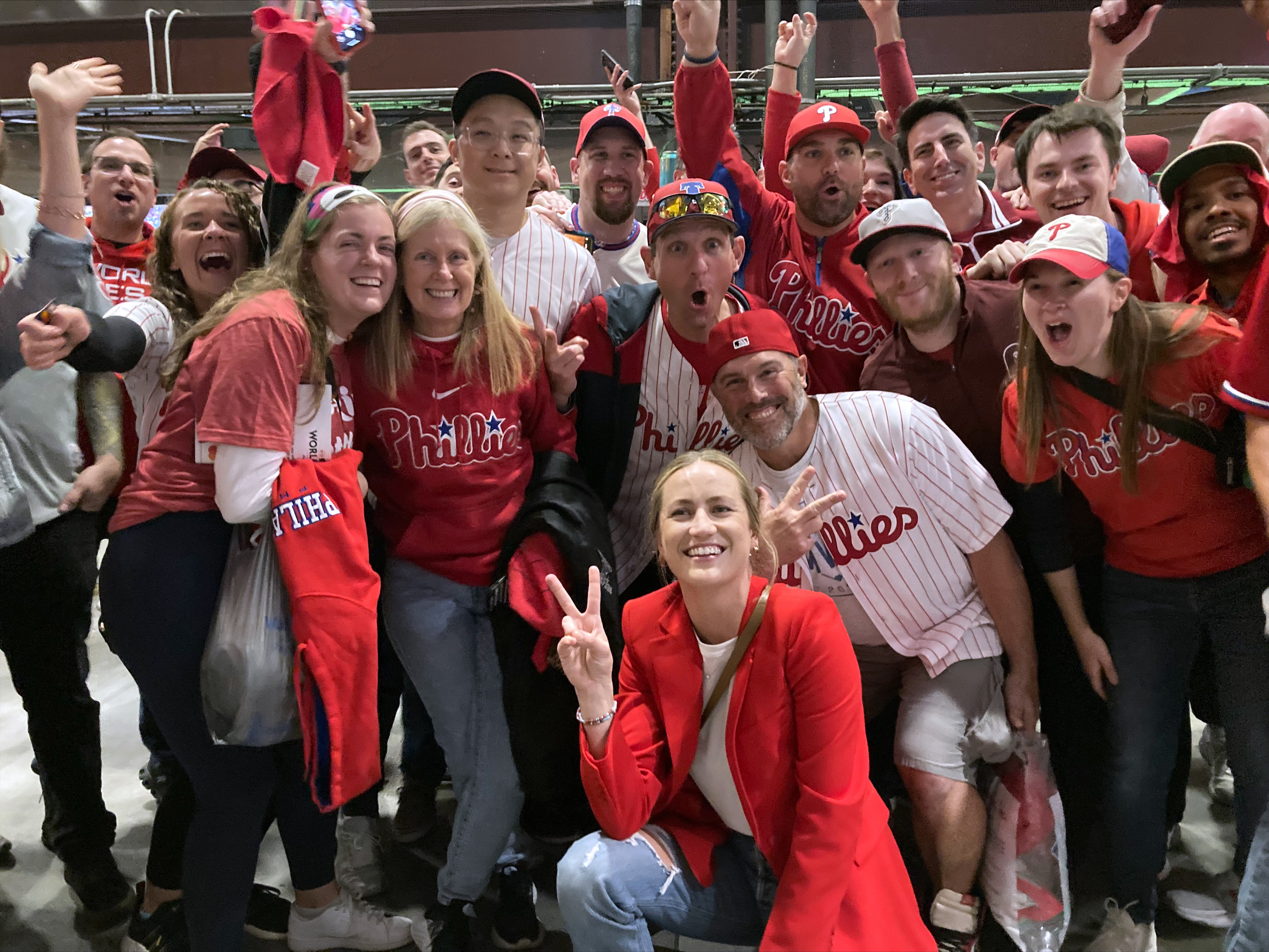 Jayme Hoskins, front, wife of Philadelphia Phillies first baseman Rhys Hoskins, poses with fans at Game 4 of the baseball World Series between the Phillies and the Houston Astros on Wednesday. Nov. 2, 2022, in Philadelphia. Hoskins tweeted she would buy fans beer before the game at Section 104 of the stadium. She paid for about 100 beers. 