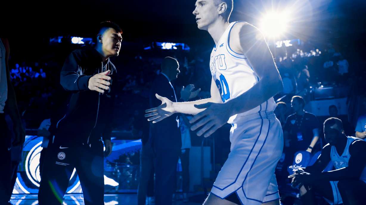 BYU wing Spencer Johnson slaps palms with freshman Hao Dong before the Cougars' 109-69 exhibition win over Ottawa (Ariz.), Wednesday, Nov. 2, 2022 in the Marriott Center in Provo.