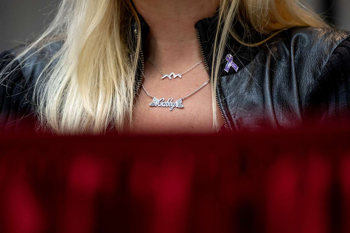 Tara Petito, stepmother of Gabby Petito, wears a “Gabby” necklace and a purple ribbon signifying domestic violence awareness during a press conference at the Utah Law and Justice Center in Salt Lake City on Thursday. Petito’s parents and attorneys announced they have filed a $50 million wrongful death lawsuit against the Moab Police Department.