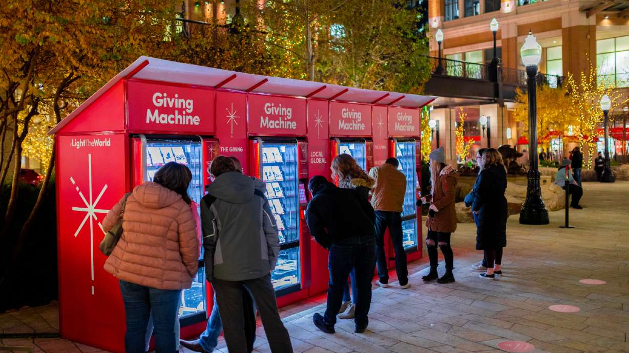Visitors purchase items from Light the World giving machines at City Creek Center in Salt Lake City. The Church of Jesus Christ of Latter-day Saints is expanding the charitable program to 28 locations worldwide.