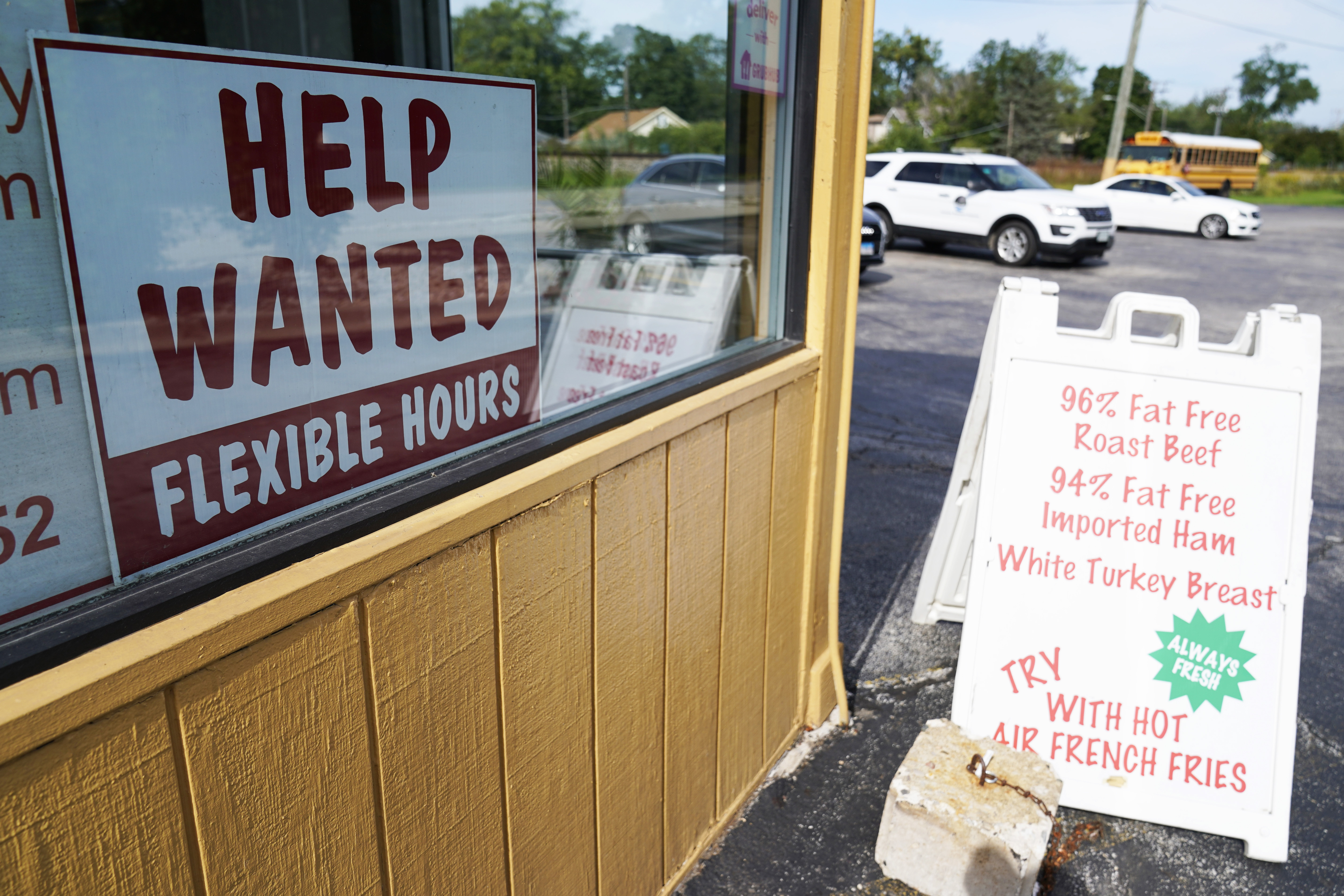 A help wanted sign is displayed in Deerfield, Ill., Sept. 21. America's employers kept hiring briskly in October, adding a substantial 261,000 positions, the government announced Friday.
