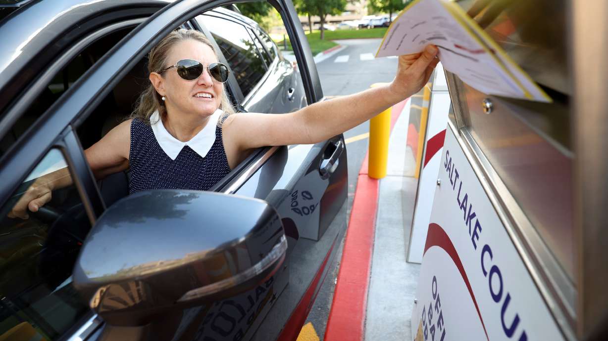 Julia Houser drops off her primary ballot outside the Salt Lake County Government Center in Salt Lake City on June 28. Iron and Carbon counties have added additional early voting days after a problem with mailed ballots not being delivered in time.