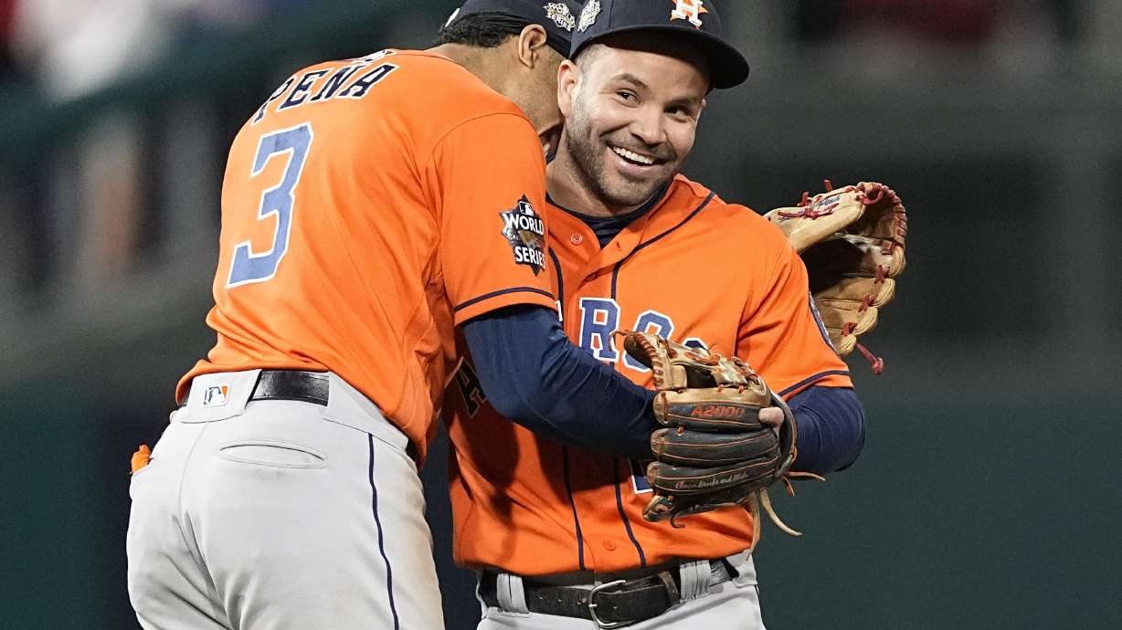 Houston Astros second baseman Jose Altuve and shortstop Jeremy Pena celebrate their win in Game 5 of baseball's World Series between the Houston Astros and the Philadelphia Phillies on Friday, Nov. 4, 2022, in Philadelphia. The Astros won 3-2, to take a one game lead in the best of seven series.