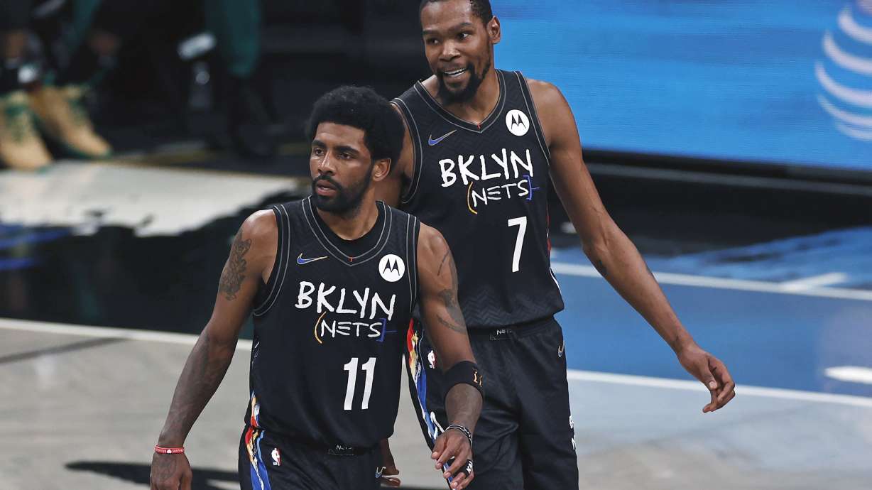 FILE - Brooklyn Nets guard Kyrie Irving (11) and Kevin Durant react against the Boston Celtics in the second half of Game 5 during an NBA basketball first-round playoff series, June 1, 2021, in New York. Kevin Durant said Friday, Nov. 4, 2022, the Brooklyn Nets could have handled this tumultuous week a bit differently — a week in which his coach was fired and teammate Kyrie Irving was suspended for posting a link to an antisemitic work.
